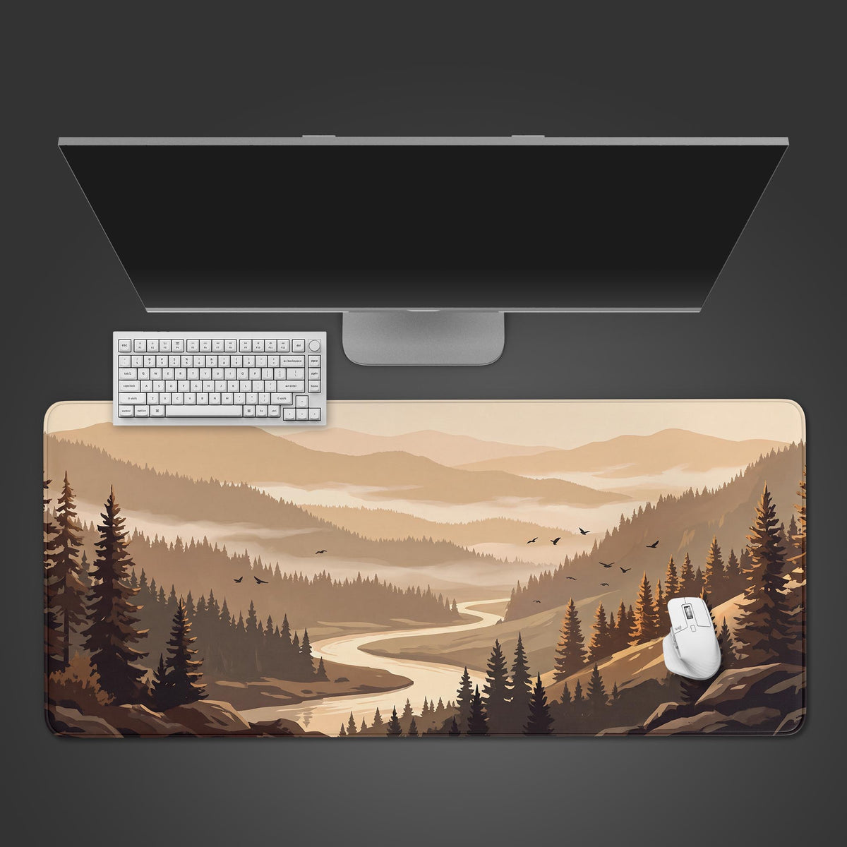 Top view of a beige forest landscape desk mat with fir trees and a river valley, below a monitor, keyboard and mouse