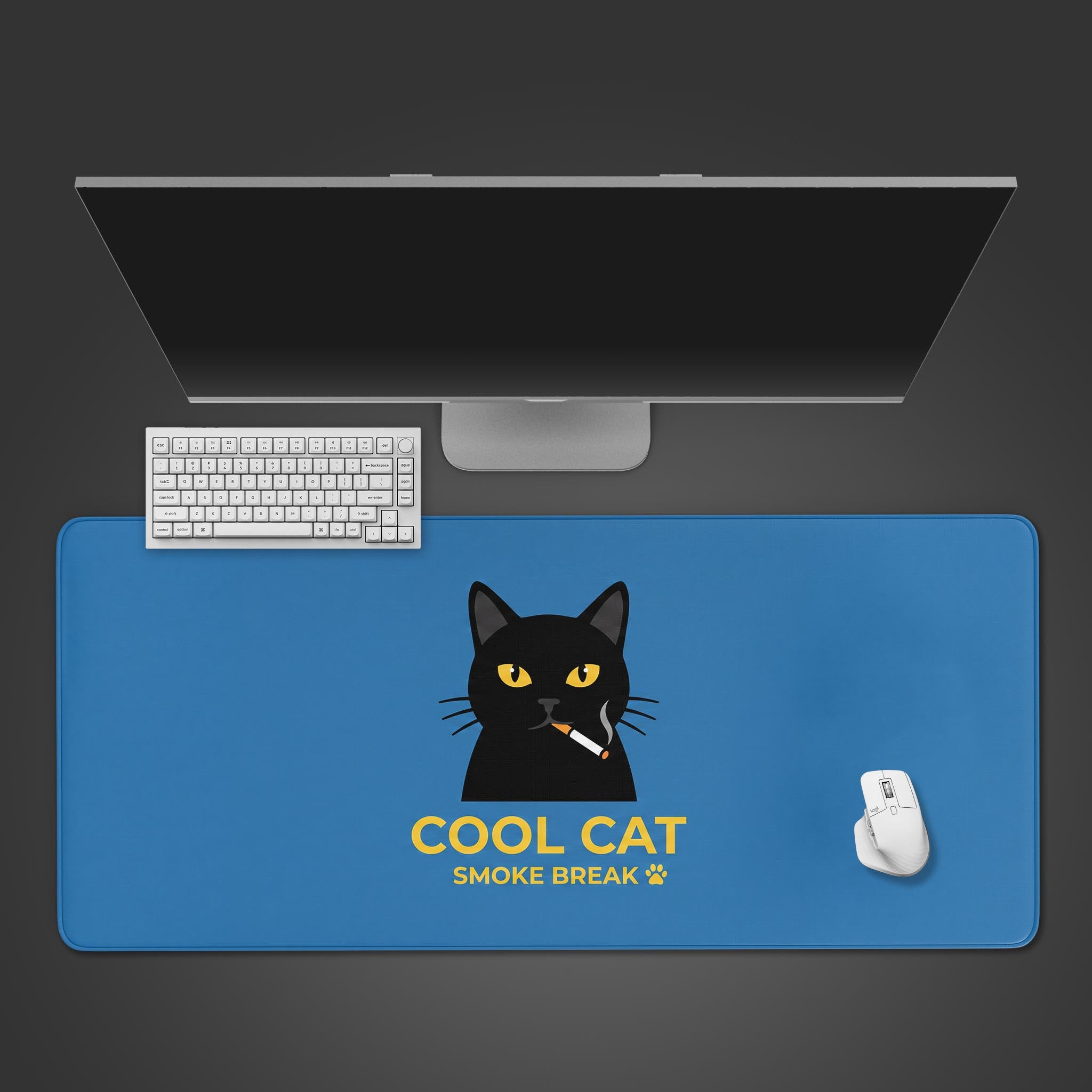A solid blue desk mat featuring a black cat smoking a cigarette with the text Cool Cat Smoke Break in yellow.