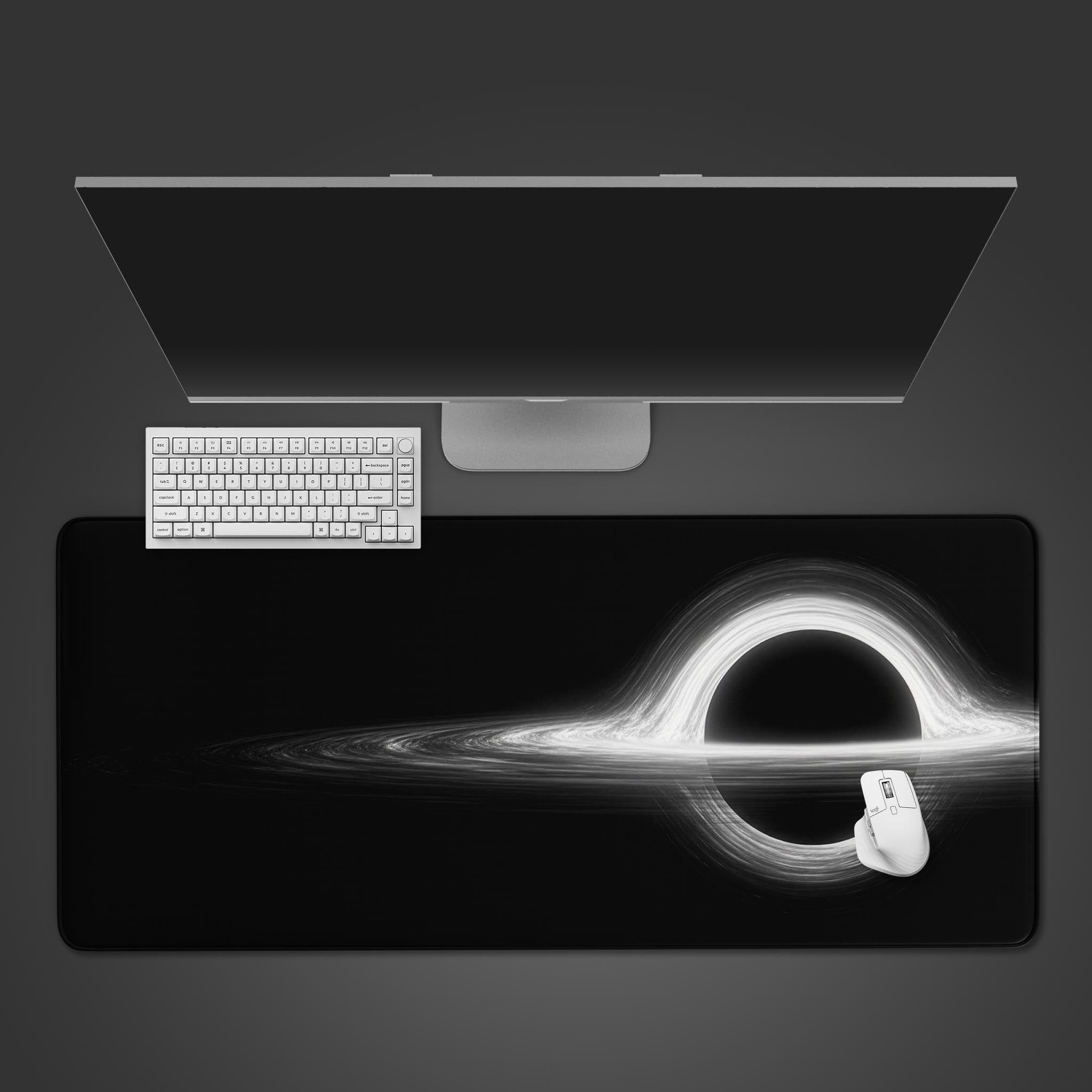 Black Hole desk mat in a minimalist desktop view with a black keyboard and mouse, showcasing the monochrome cosmic design. - Epic Design Pads