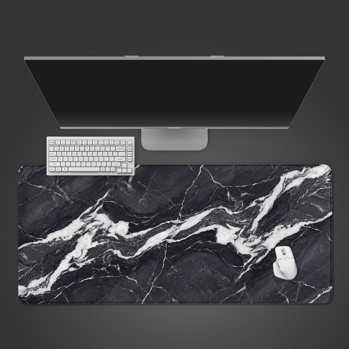 A sleek desk mat displaying a high-contrast black and white marble stone texture.