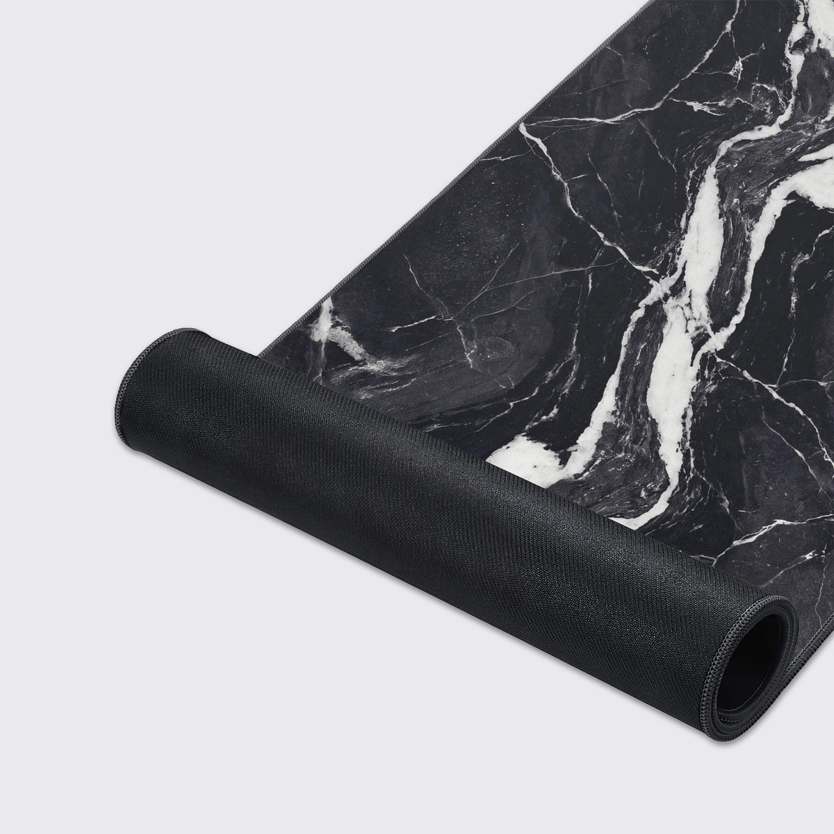 A flat view of the elegant black marble design spanning horizontally across the desk mat.