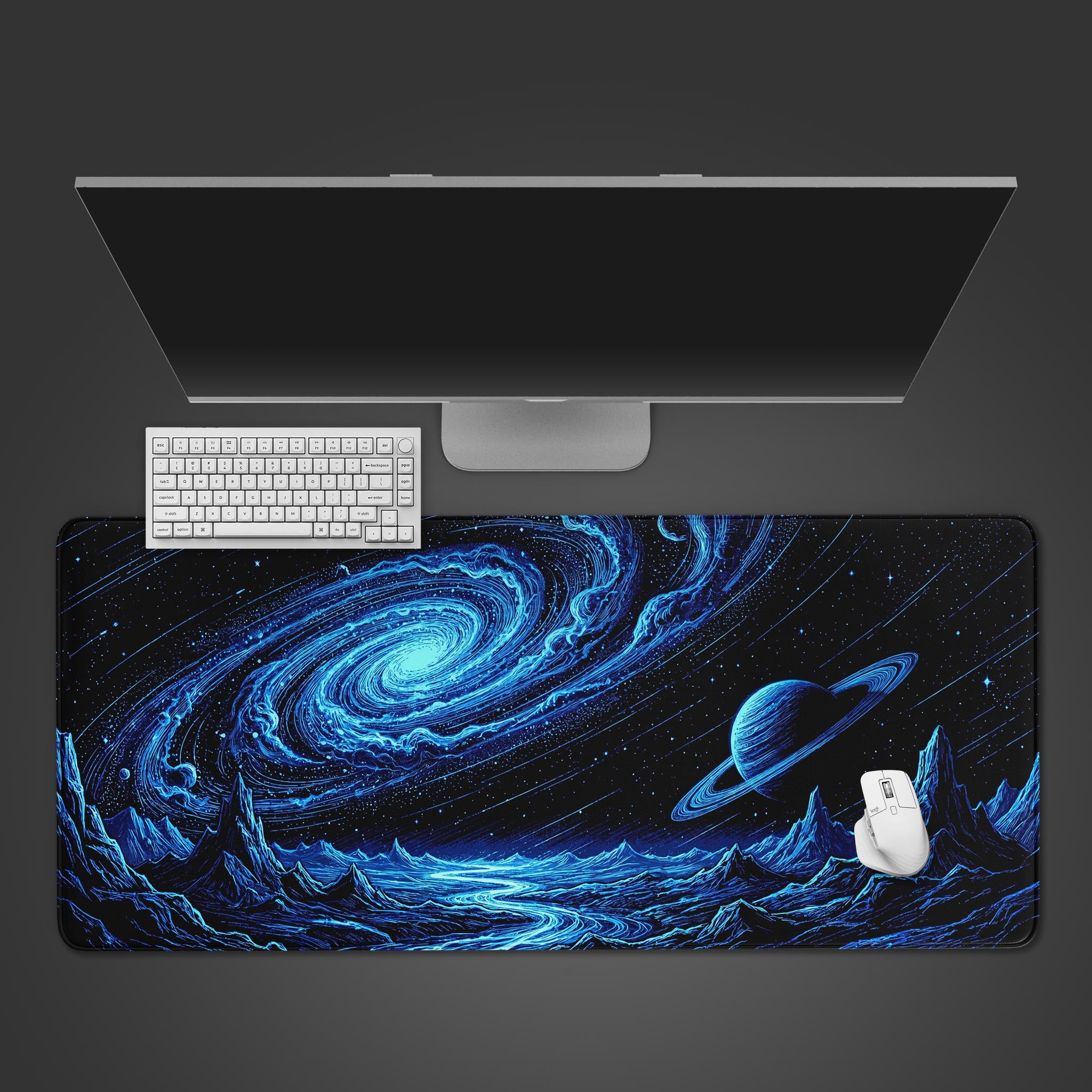 A large desk mat featuring a swirling blue galaxy, a ringed planet, and a rugged alien landscape, displayed flat.