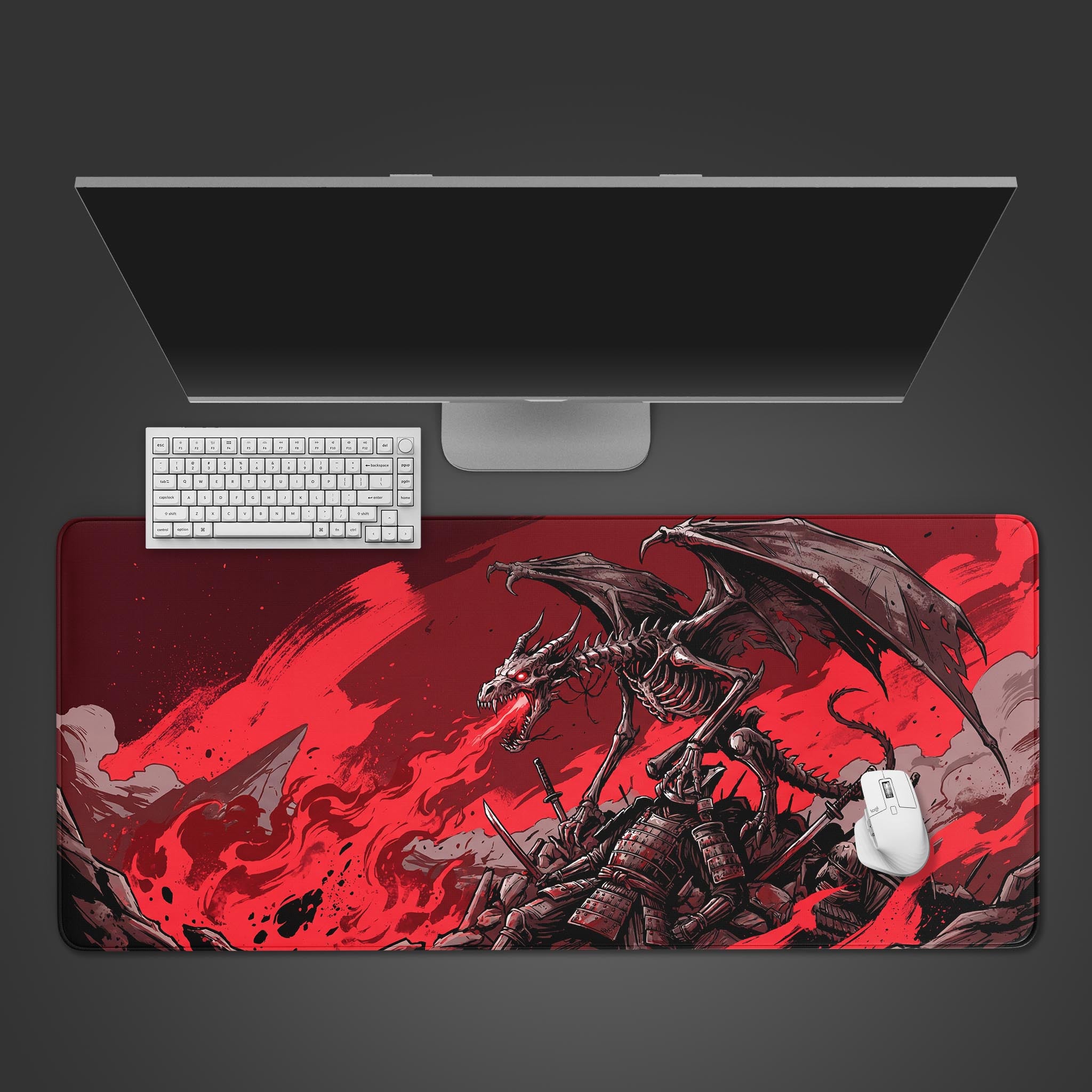 Top-down view of the Bone Tyrant gaming desk mat featuring a skeletal dragon, shown with a white keyboard, mouse, and monitor on a dark background. - Epic Design Pads & Mousepads