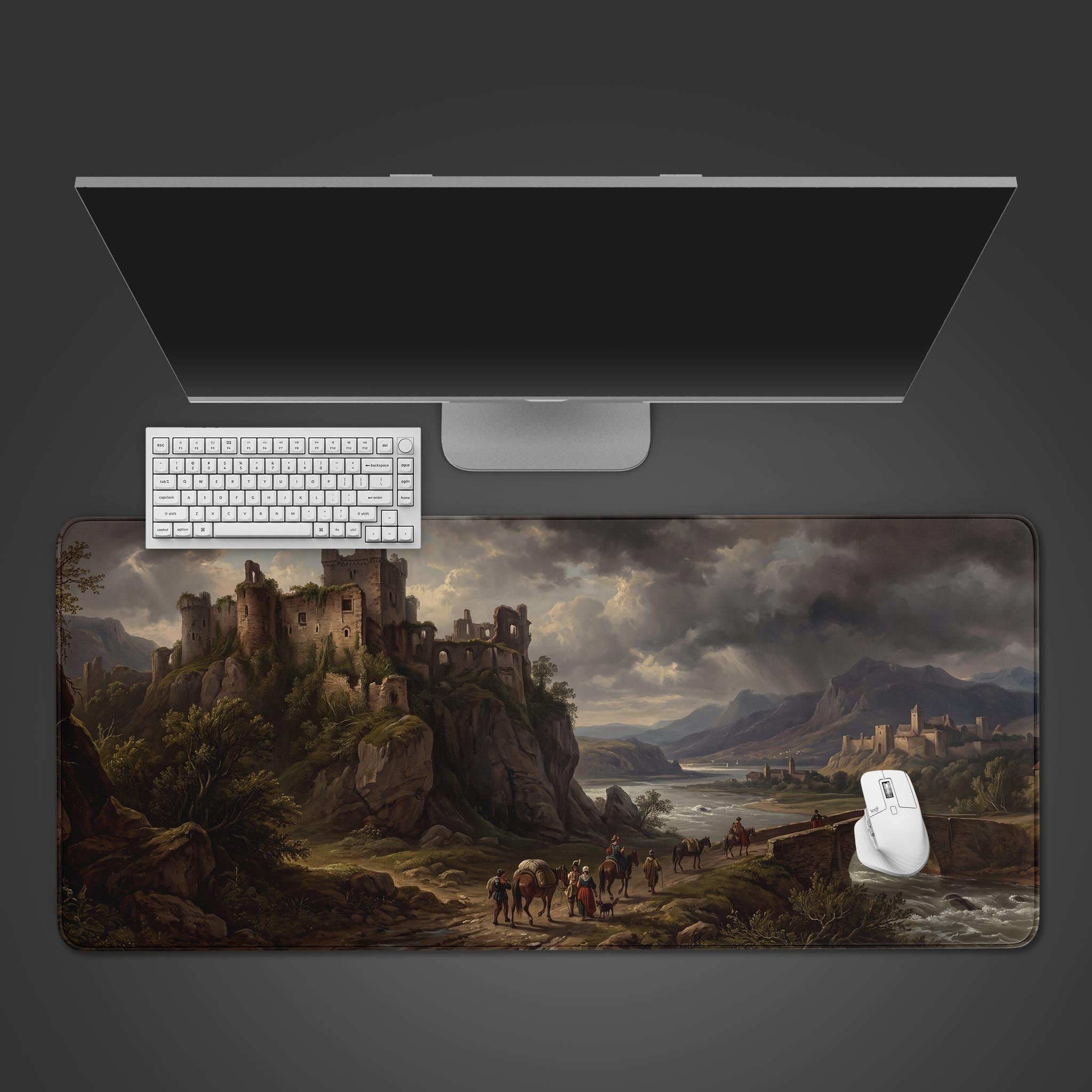 A desk mat featuring a sprawling medieval landscape with a towering stone castle on a cliff edge overlooking a valley.
