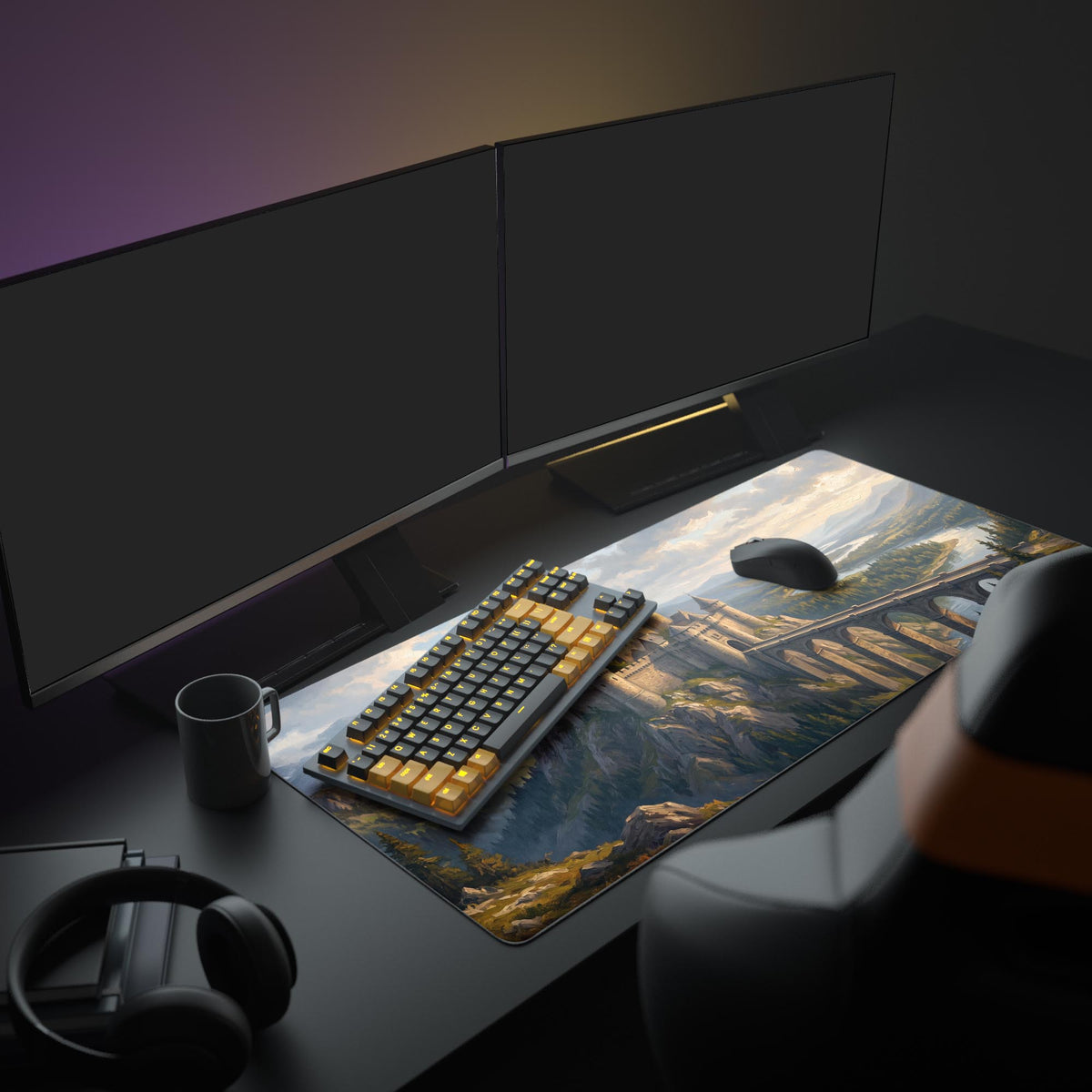 Castle and stone bridge desk mat on a dark desk in a room with two monitors, keyboard, mouse, mug and headphones