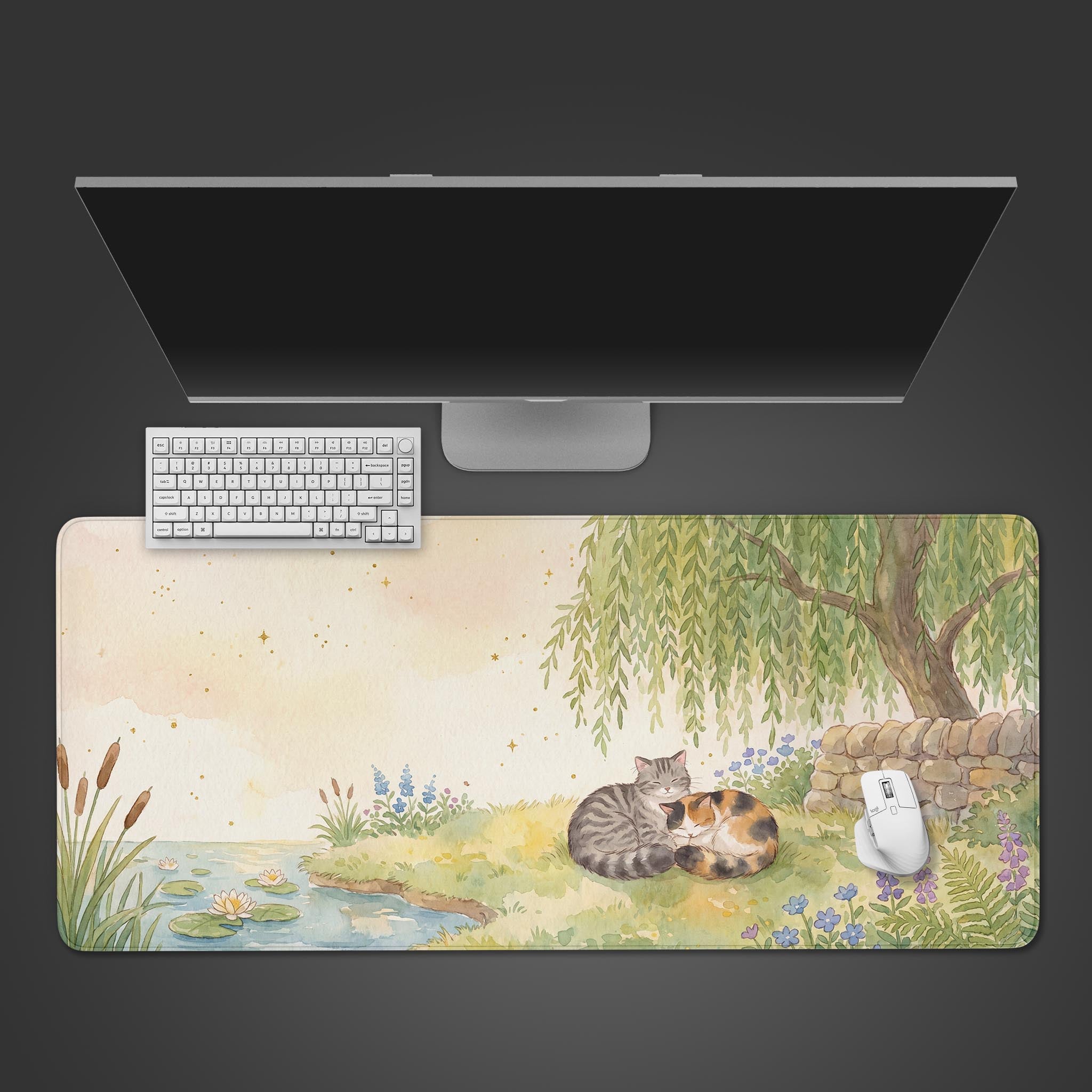 A serene watercolor desk mat featuring a tabby and calico cat sleeping under a weeping willow tree by a lily pond.