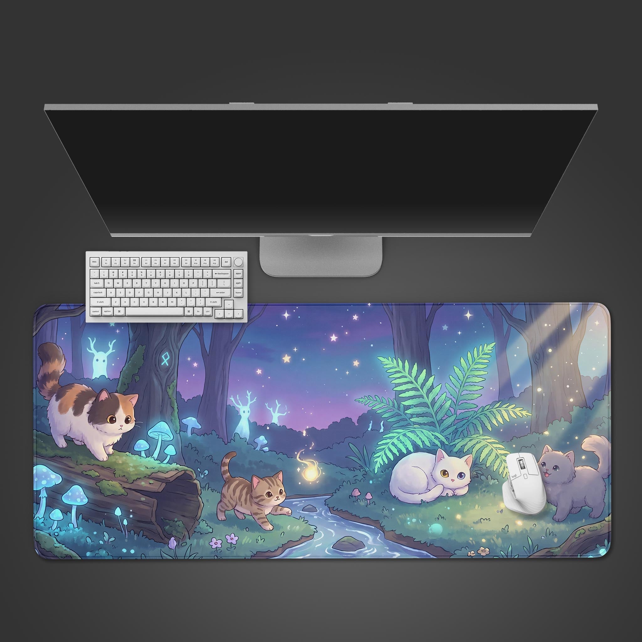 A desk mat featuring four cute cats exploring an enchanted nighttime forest with a starry sky.