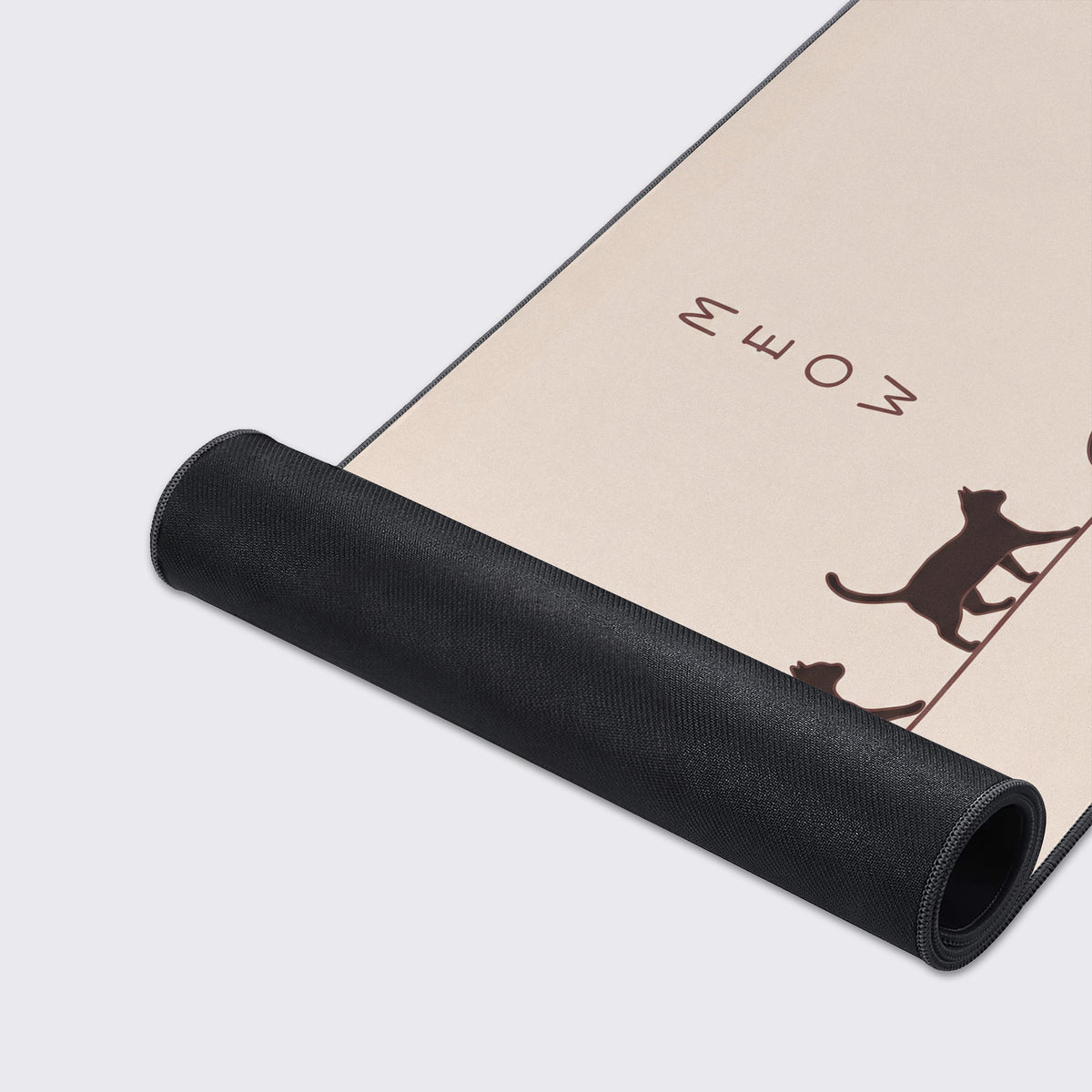Close-up detail of cat silhouettes walking and playing on a warm beige mouse pad.
