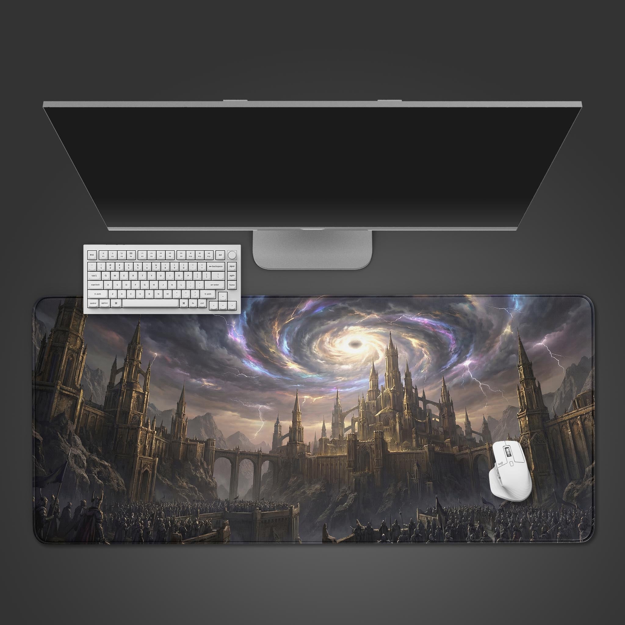 A top-down view of the Celestial Siege gaming desk mat, showing the dark fantasy castle artwork beneath a minimalist keyboard, white mouse, and a large monitor on a grey desk. - Epic Design Pads & Mousepads