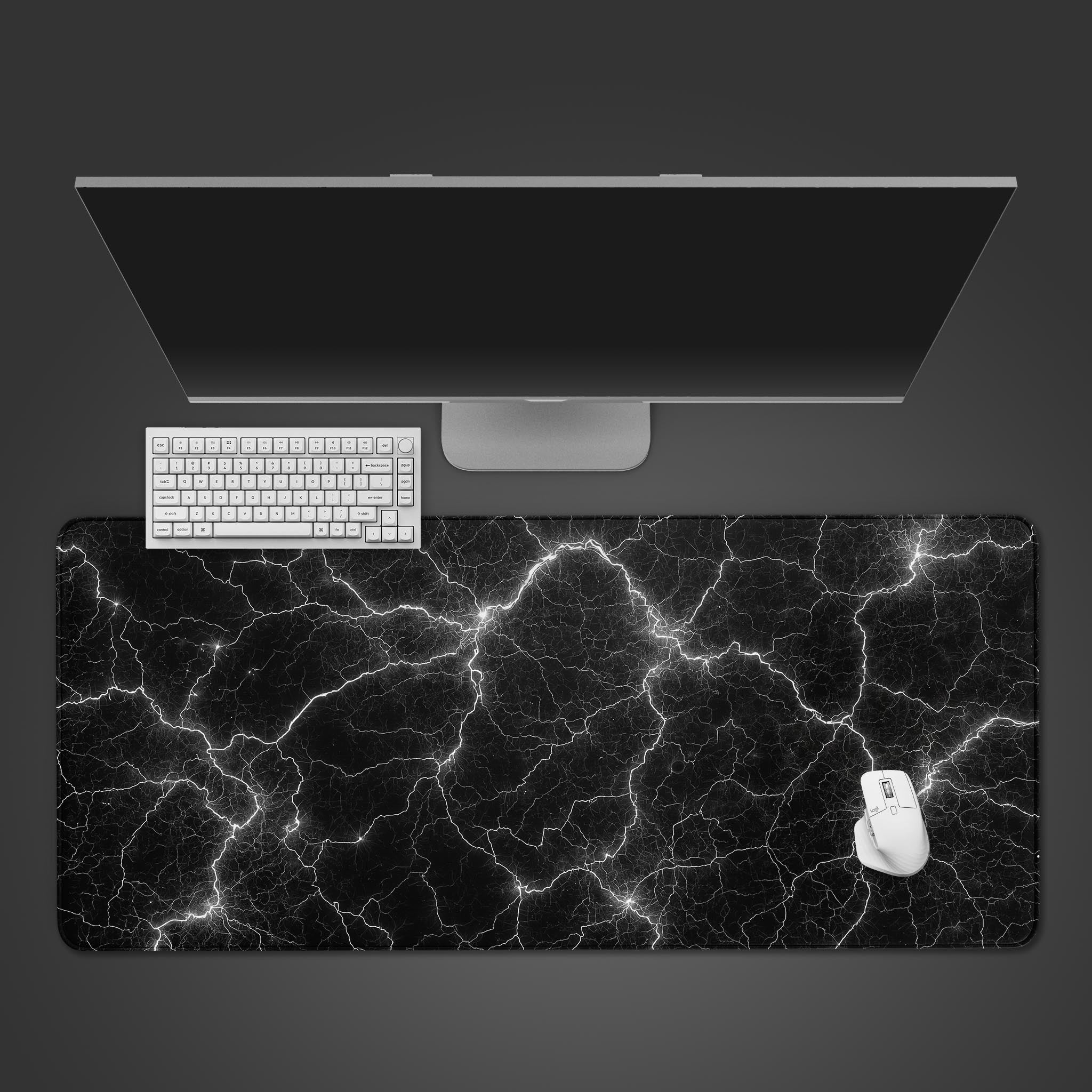 Chaos Current desk mat with abstract white lightning design, shown from a top-down desktop view with a black keyboard and mouse. - Epic Design Pads