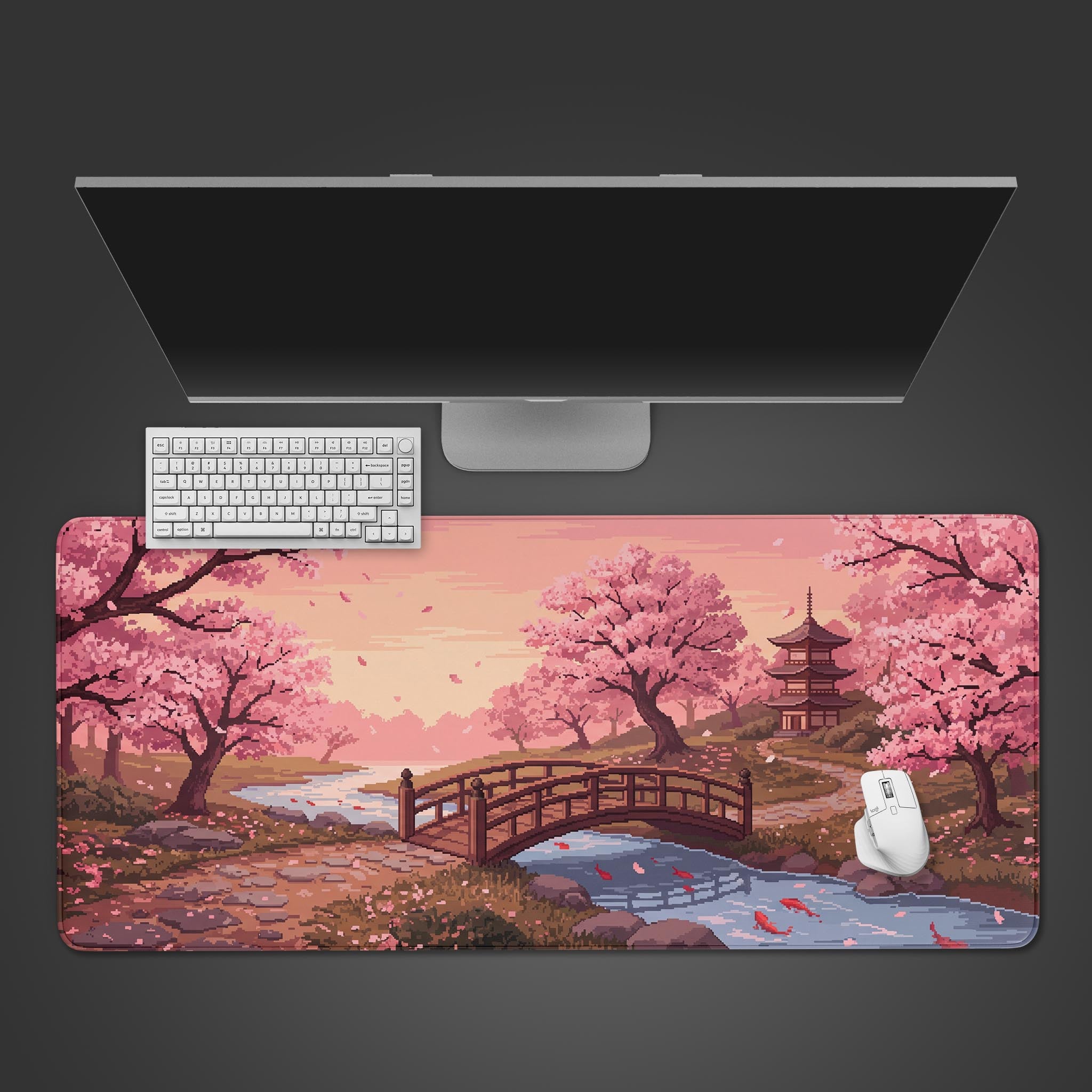 A pixel art desk mat featuring pink cherry blossoms, a wooden bridge over a stream with koi fish, and a pagoda in the background.