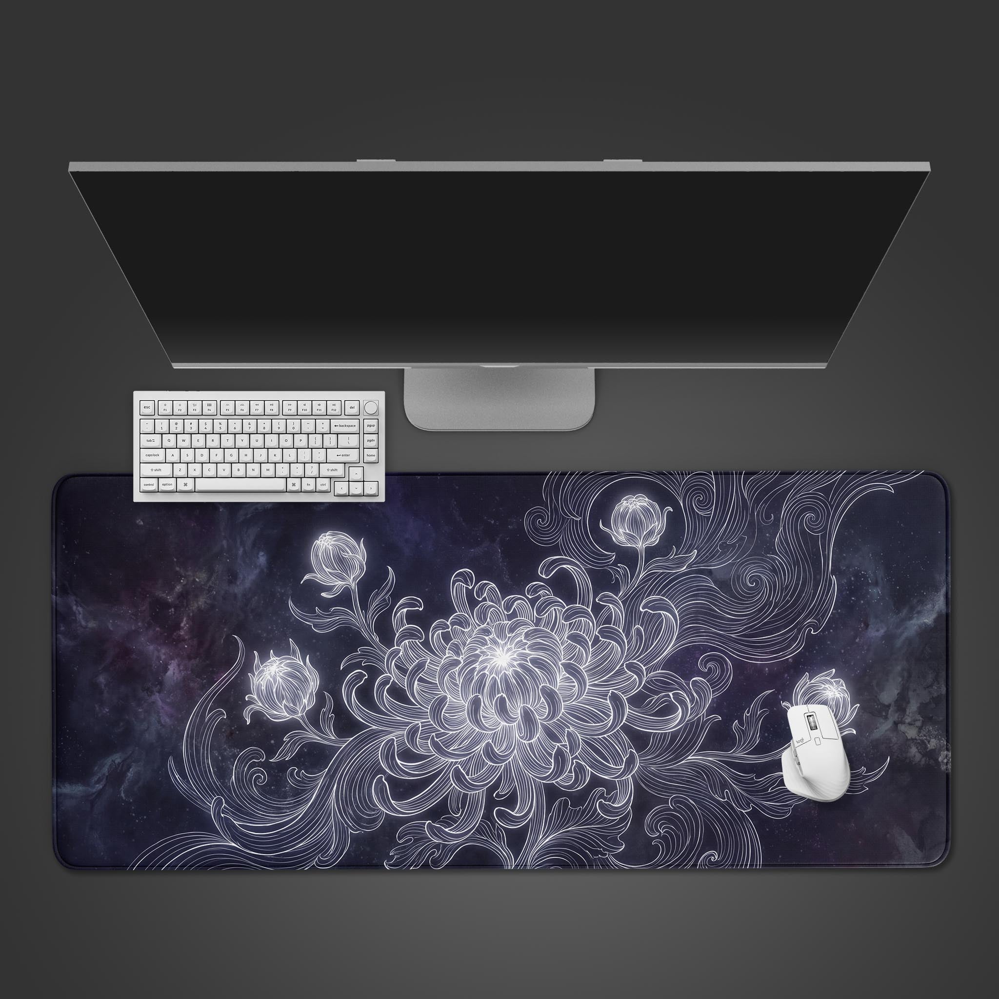 A desk mat featuring a glowing white line-art chrysanthemum blooming against a dark cosmic nebula background.