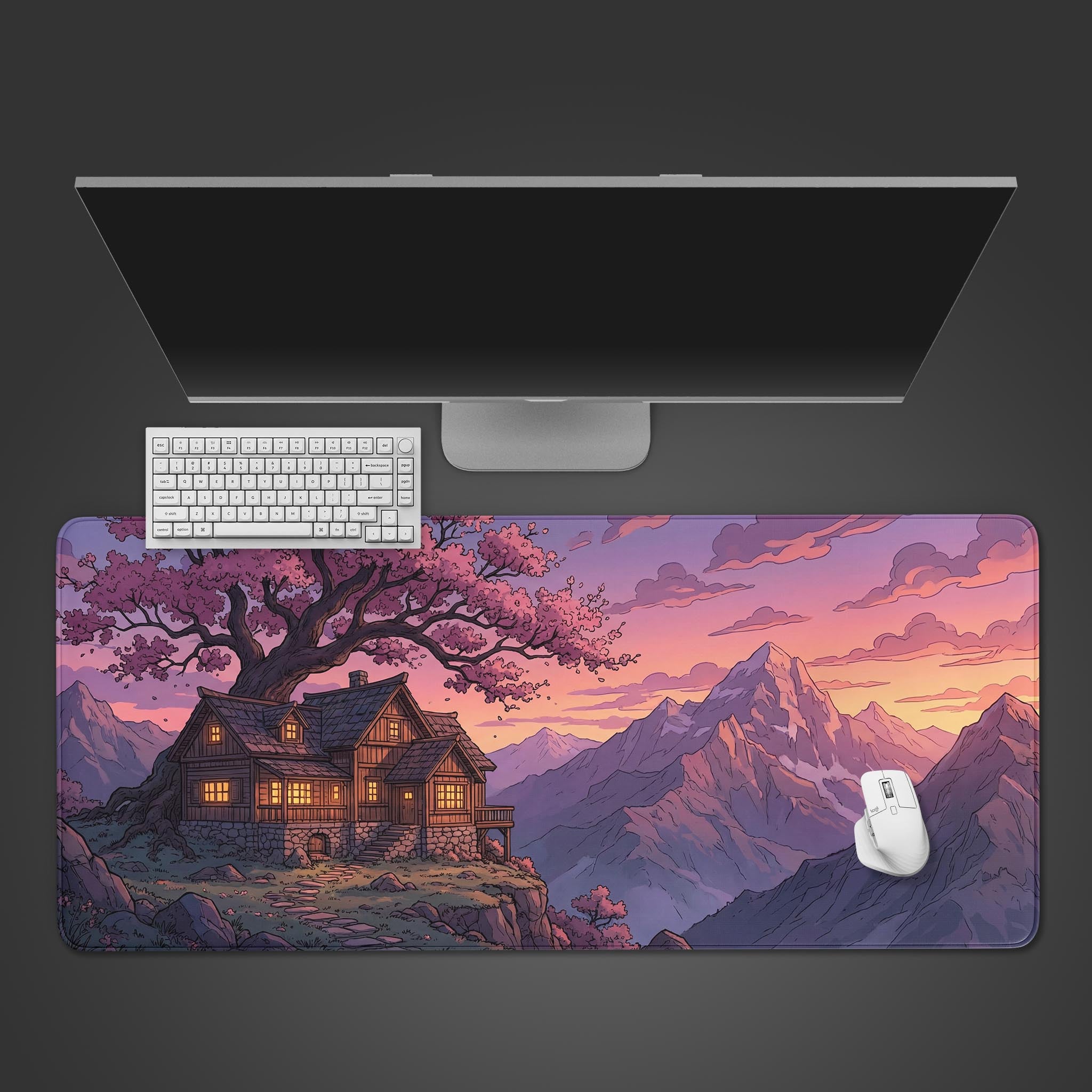 Top-down view of the Cliffside Haven gaming desk mat, showing the mountain cabin design beneath a sleek monitor, white keyboard, and mouse. A complete, organized desk setup. - Epic Design Pads & Mousepads