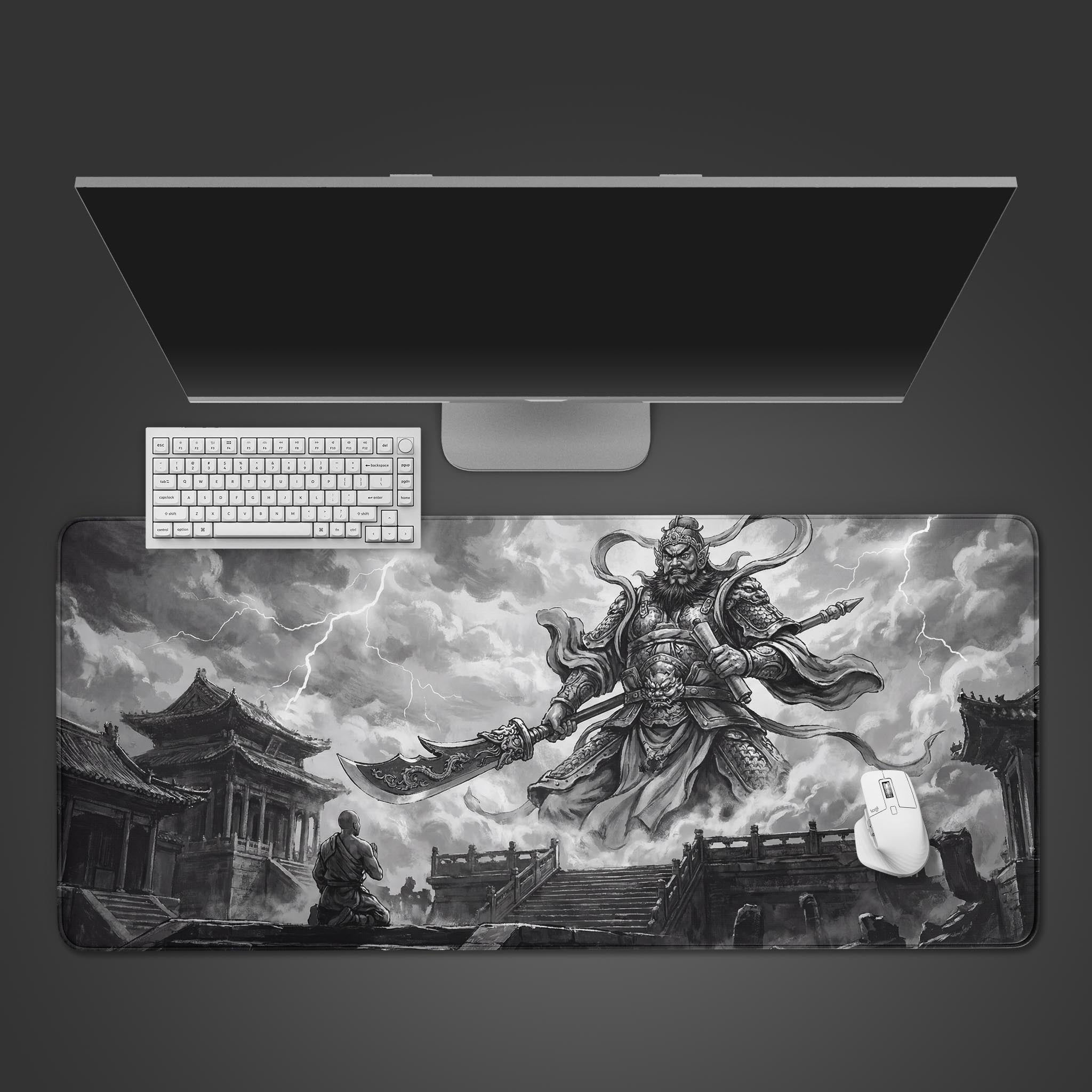 Top-down view of the Cloud Deity gaming desk mat featuring a monochrome Chinese god of war, shown with a white keyboard and mouse on a dark surface. - Epic Design Pads & Mousepads