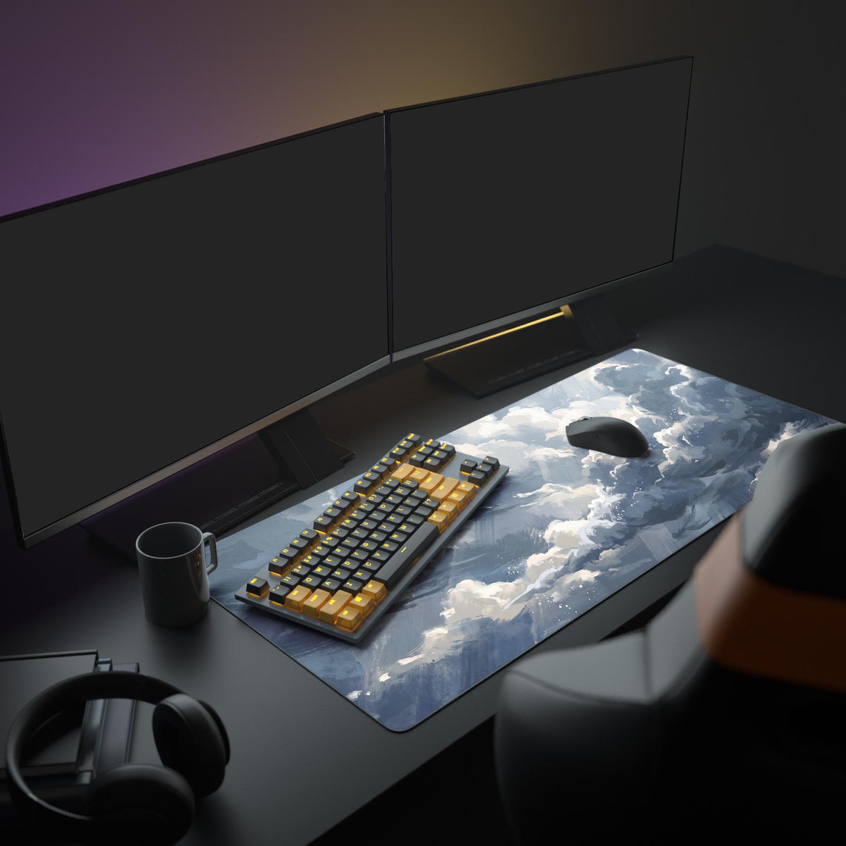 Painted storm clouds desk mat on a dark desk with two monitors, black and orange keyboard, mouse, mug and headphones