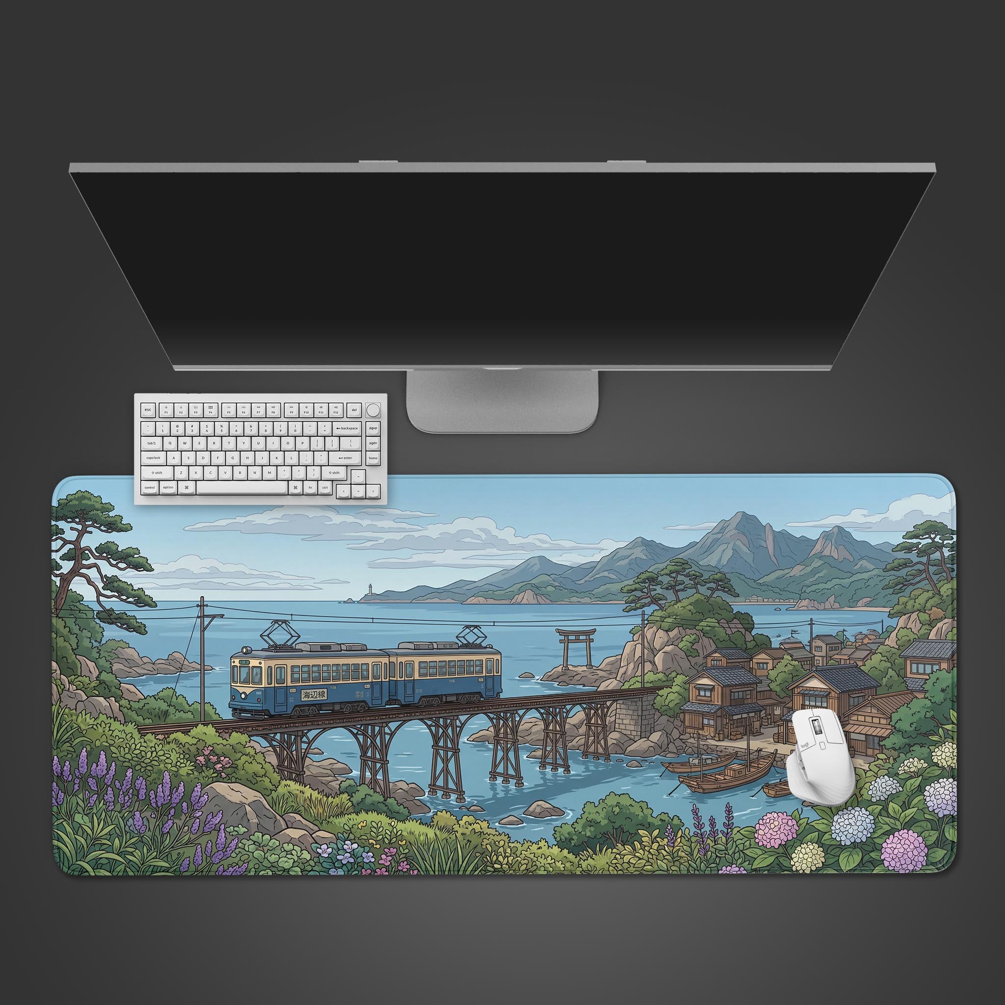 Top-down view of the Coastal Transit anime gaming desk mat, featuring a Japanese train scene, with a white keyboard and mouse neatly arranged on top. - Epic Design Pads & Mousepads