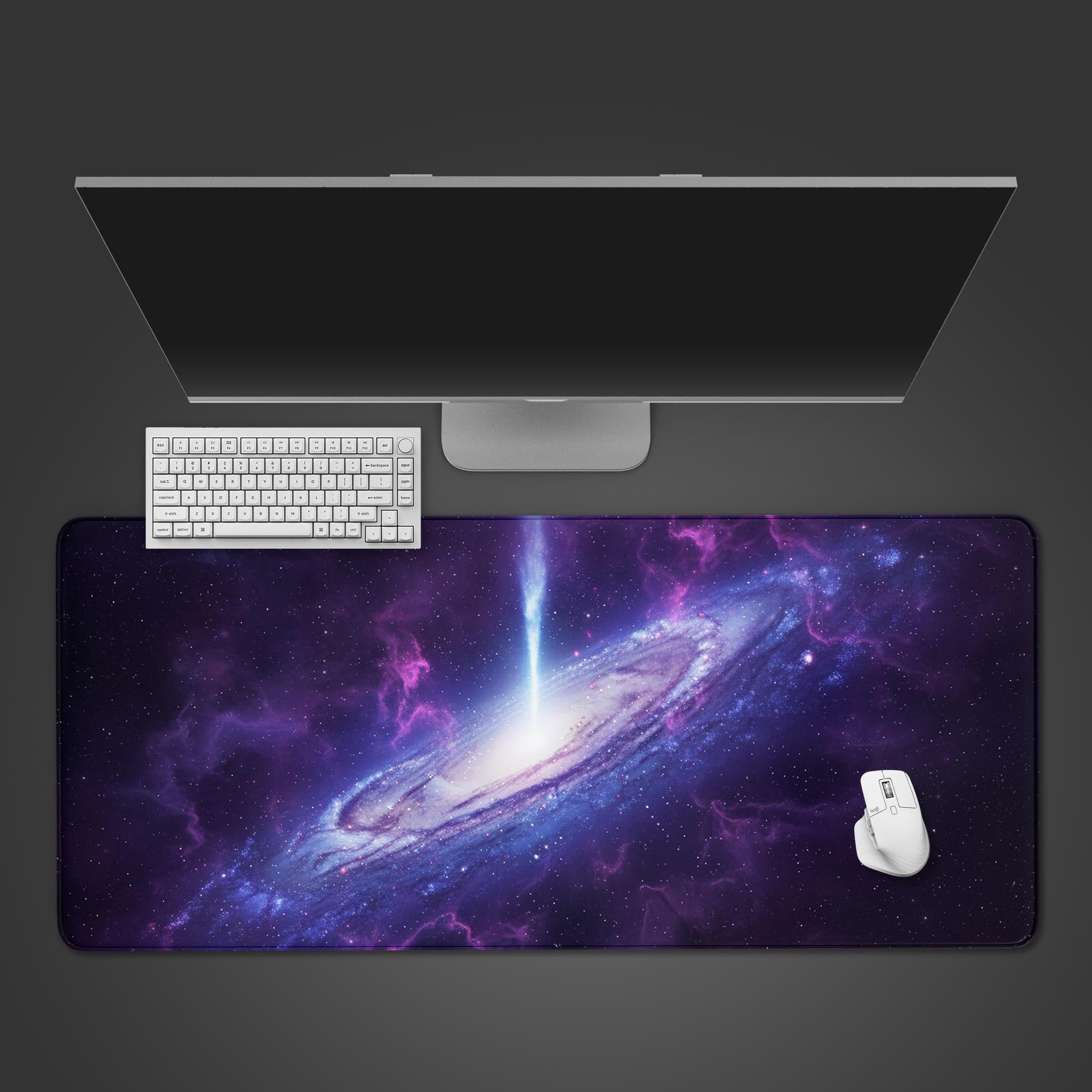 Cosmic Eruption gaming desk mat with a purple and blue galaxy design, viewed from top-down with a black keyboard and gaming mouse. - Epic Design Pads