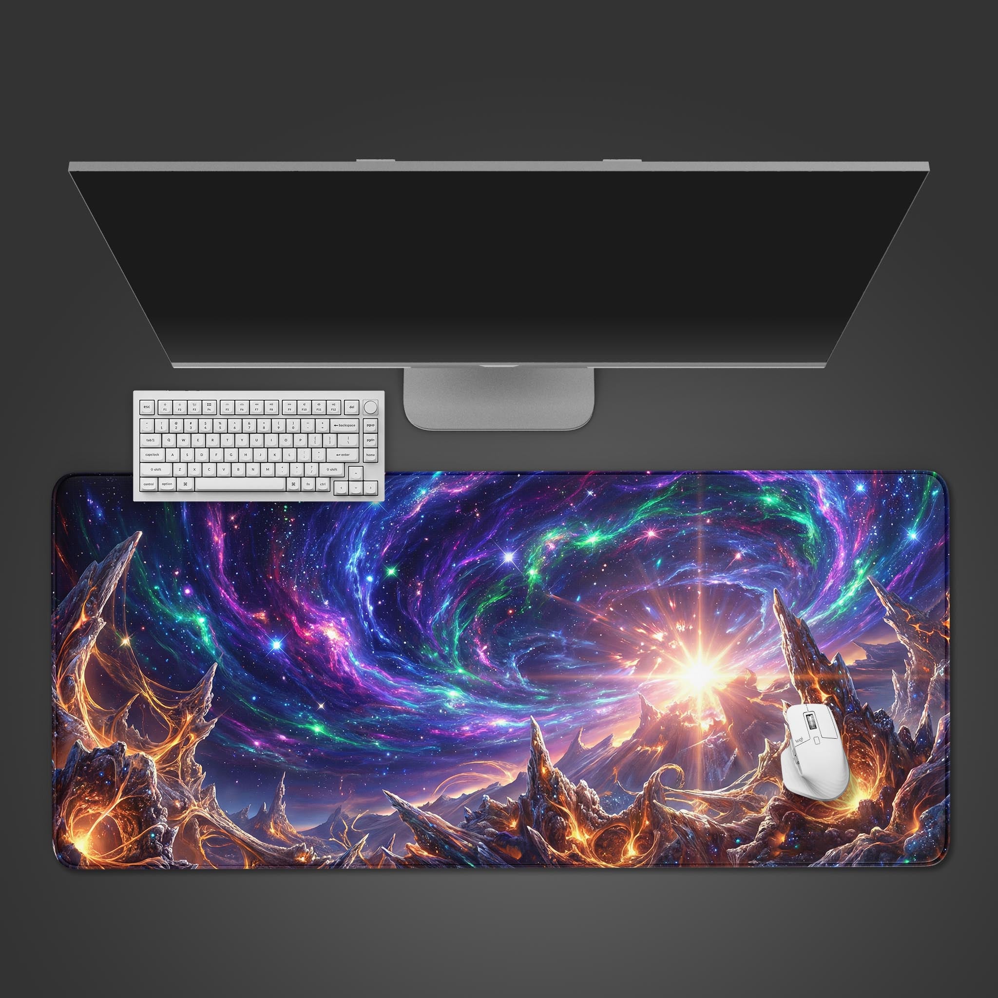 A top-down view of the Cosmic Genesis gaming desk mat, showing its vibrant nebula and molten landscape design underneath a white keyboard and monitor. - Epic Design Pads & Mousepads