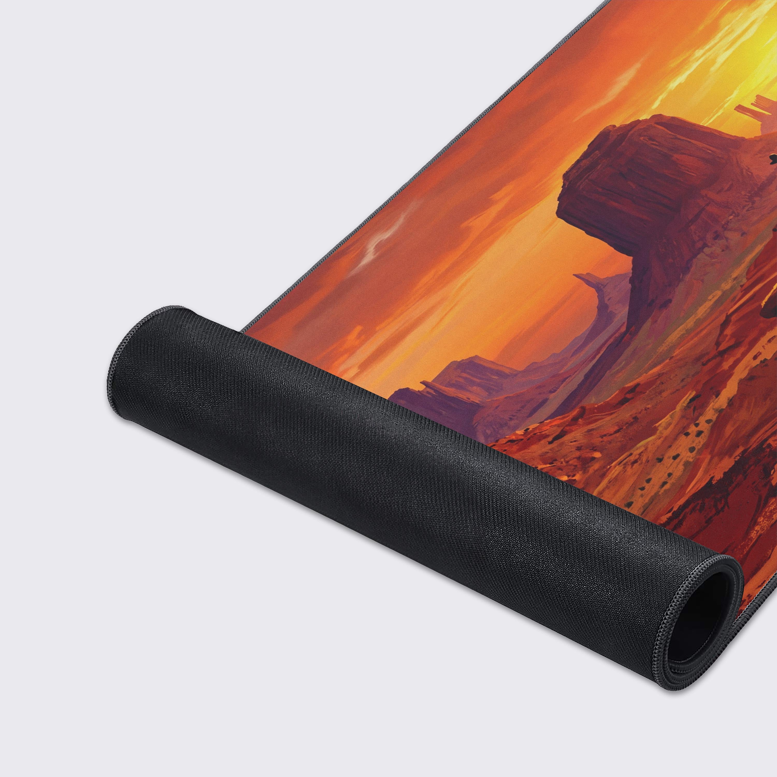 Detail of the vibrant orange and red sunset sky over the desert canyon on the desk mat.