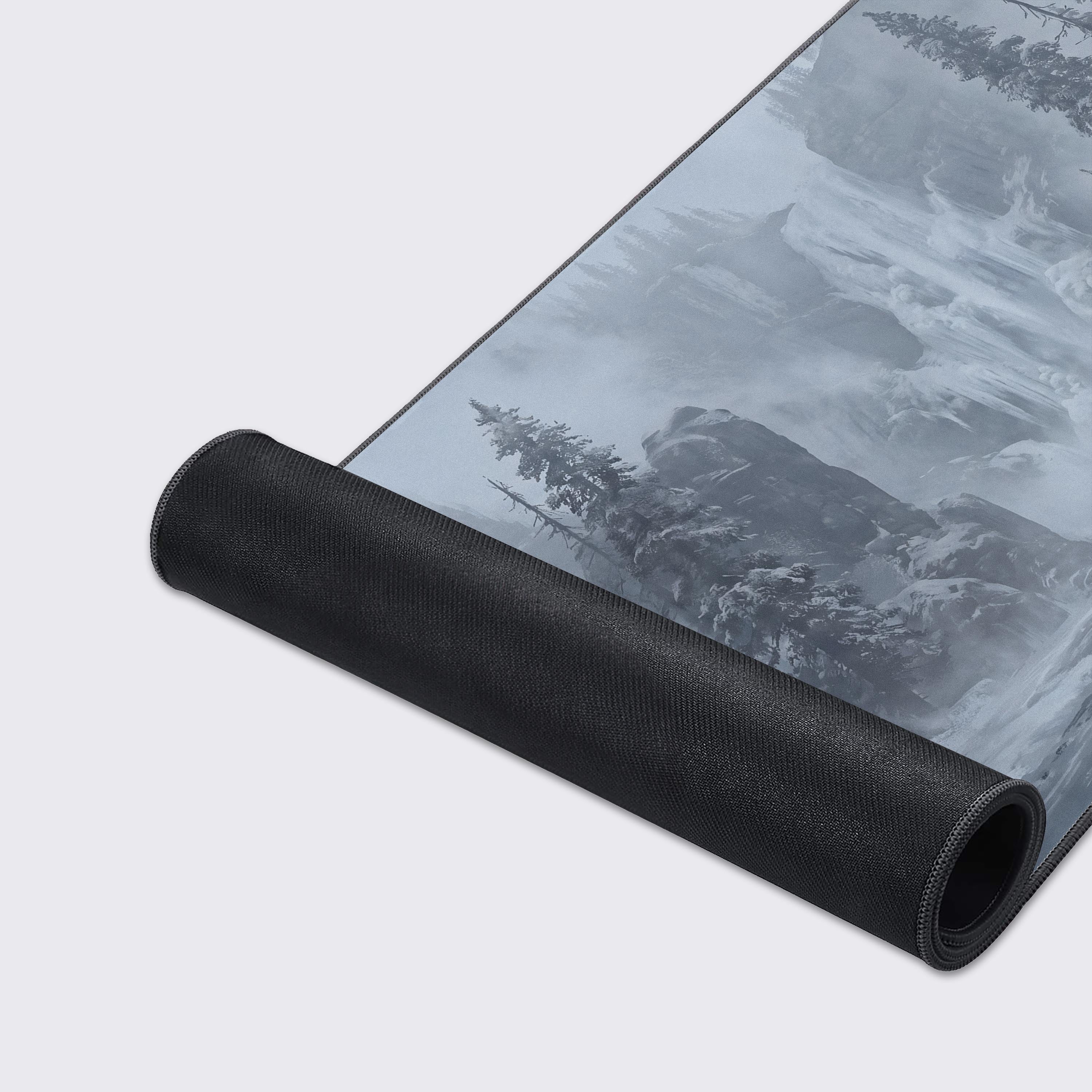 Detail of the frozen waterfall and snow-covered evergreen trees in the majestic background of the desk mat.