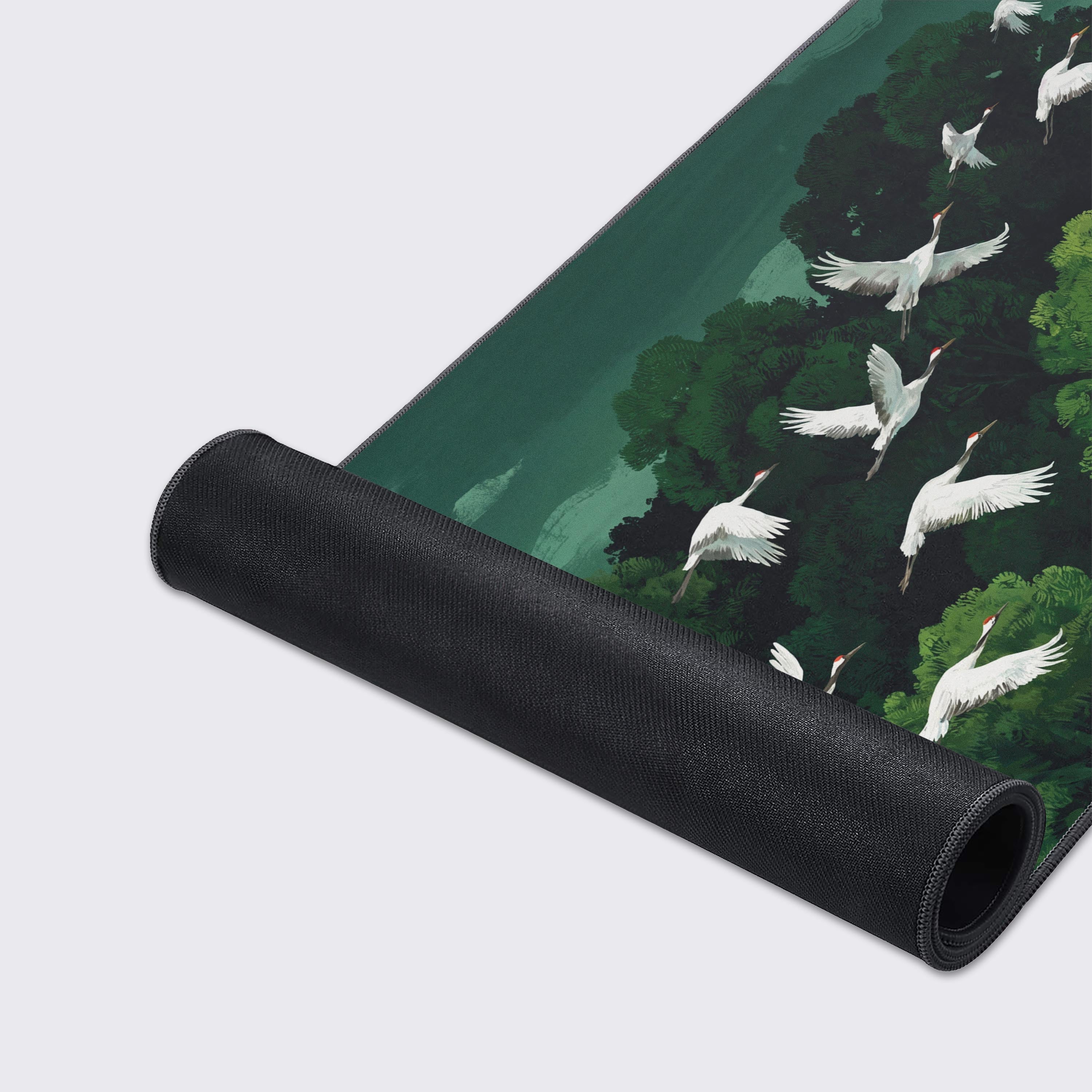 The Emerald Crane Flight extended gaming mouse pad displayed with its water-proof, smooth surface and non-slip base.