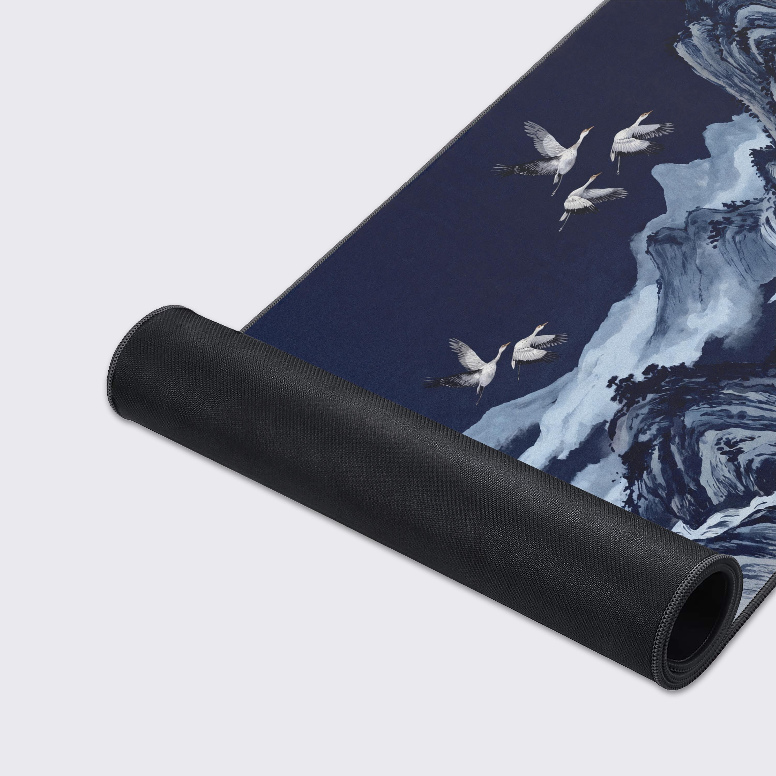 Top-down view of a zen workspace setup anchored by the blue traditional ink wash desk mat.