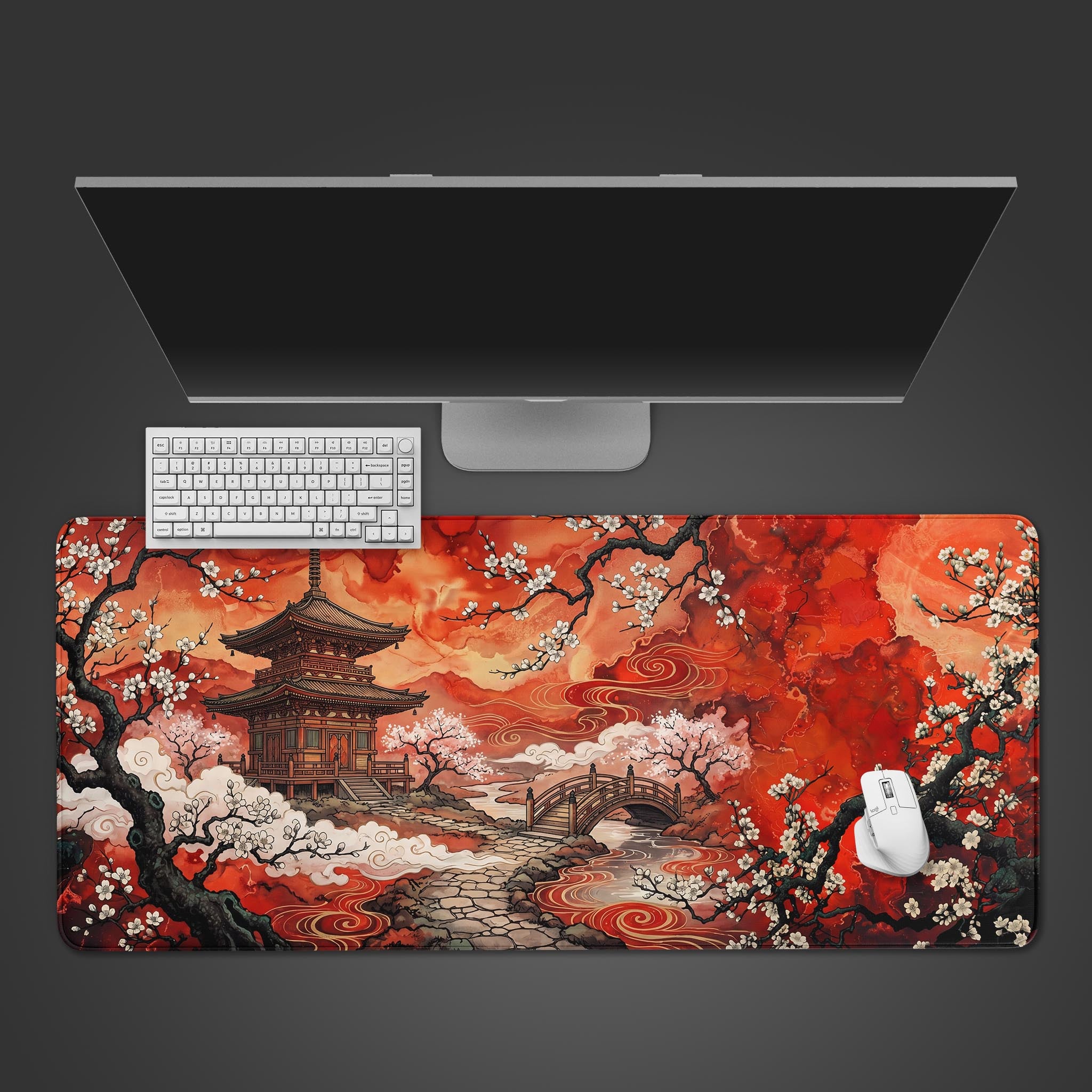 A large desk mat featuring a vibrant red fantasy landscape with a traditional Asian pagoda, arched stone bridge, and white blossoming trees.