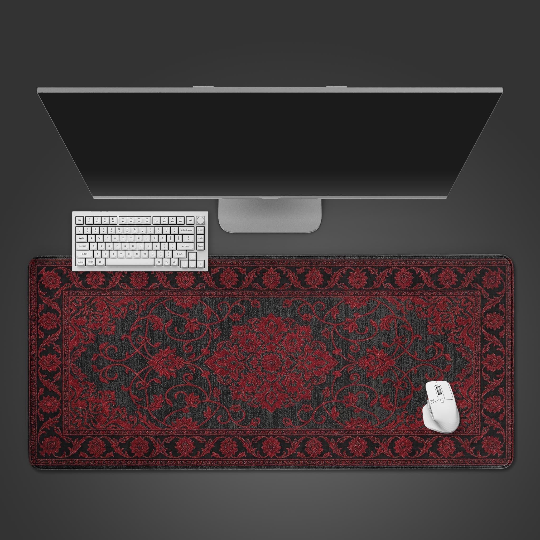 Crimson Persian rug desk mat shown from a top-down view on a wooden desk, with a black keyboard and mouse placed on its intricate vintage pattern. - Epic Design Pads & Mousepads