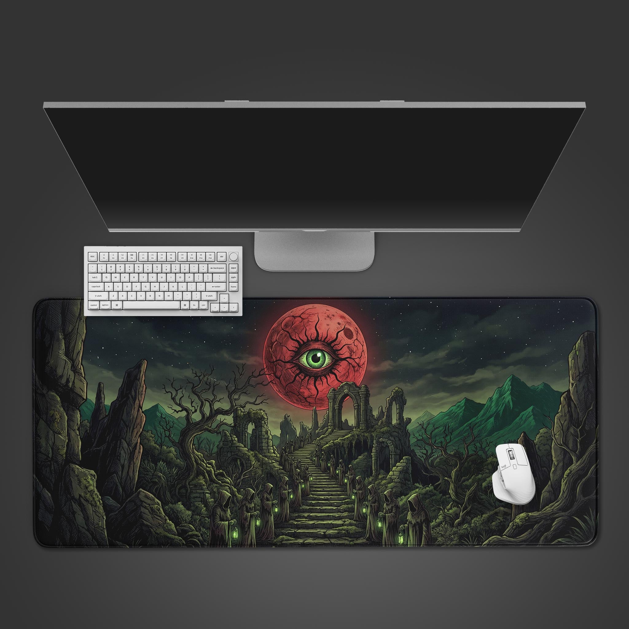Top-down view of the Crimson Ritual gaming desk mat, featuring a giant red eye in the sky, displayed with a white keyboard and mouse on a dark desk. - Epic Design Pads & Mousepads