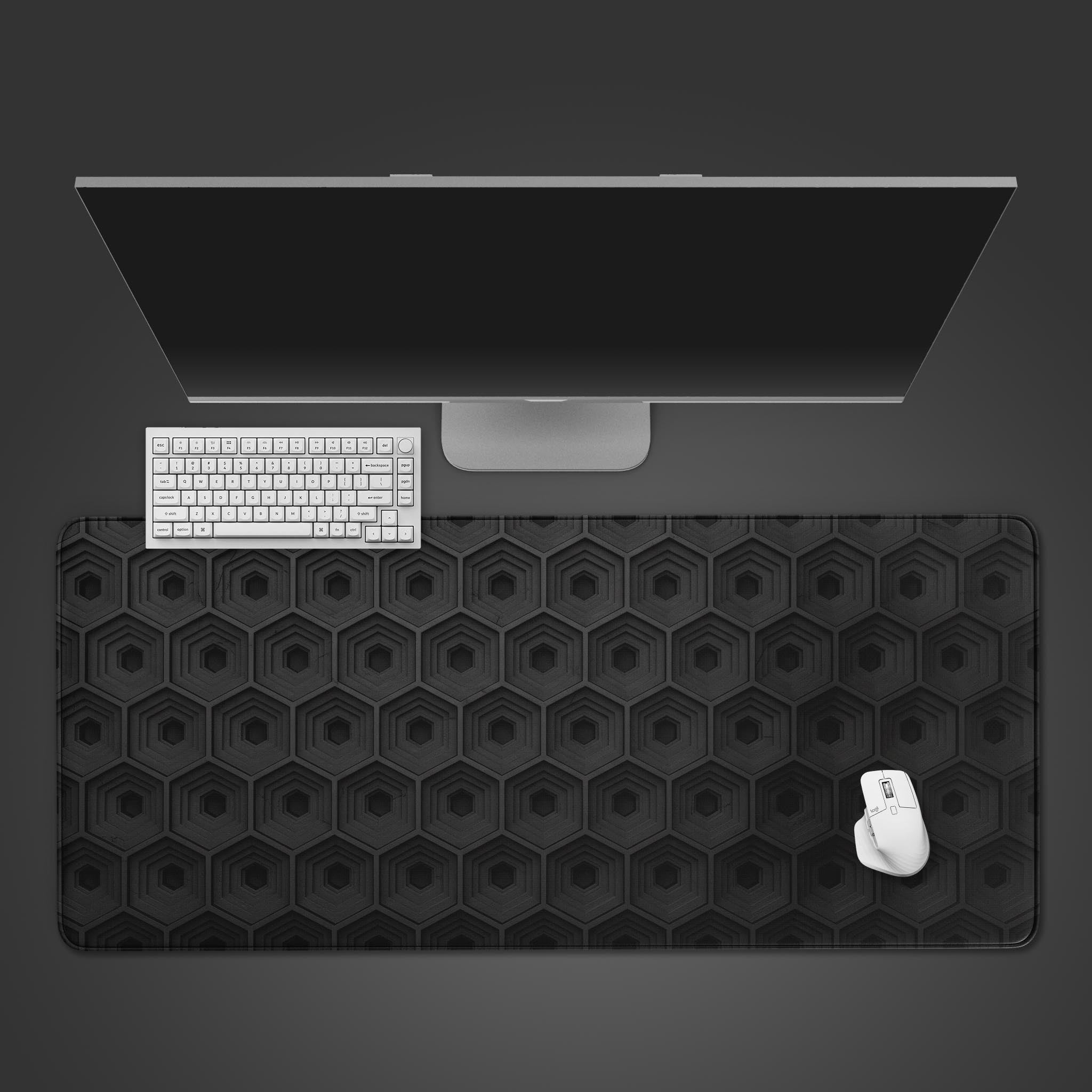 Deep Hive desk mat with abstract 3D hexagon pattern. Top-down view showing a modern keyboard and mouse on the large monochrome mouse pad. - Epic Design Pads & Mousepads
