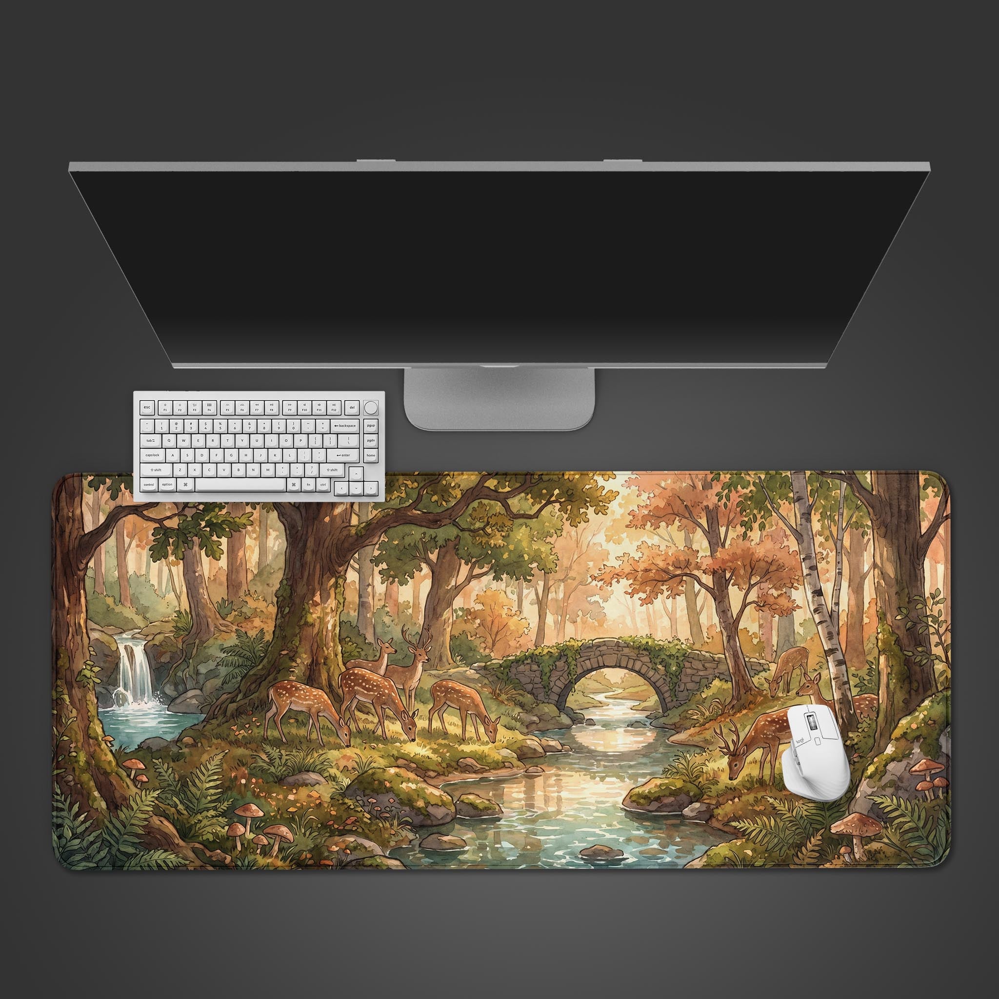 Enchanted Woodland desk mat featuring a scenic illustration of spotted deer grazing by a forest stream.