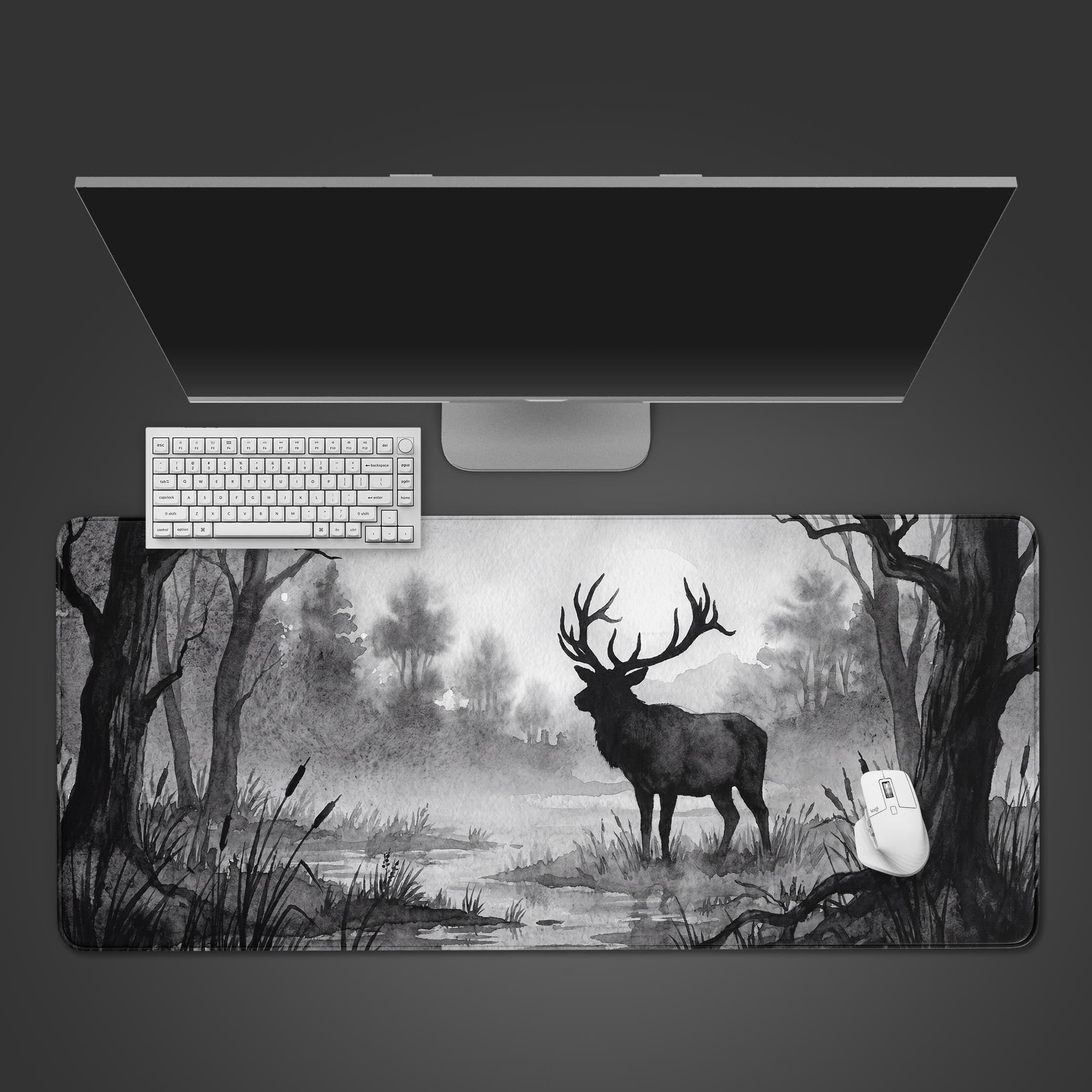 A black and white watercolor style desk mat featuring a majestic deer standing in a misty forest near a lake.