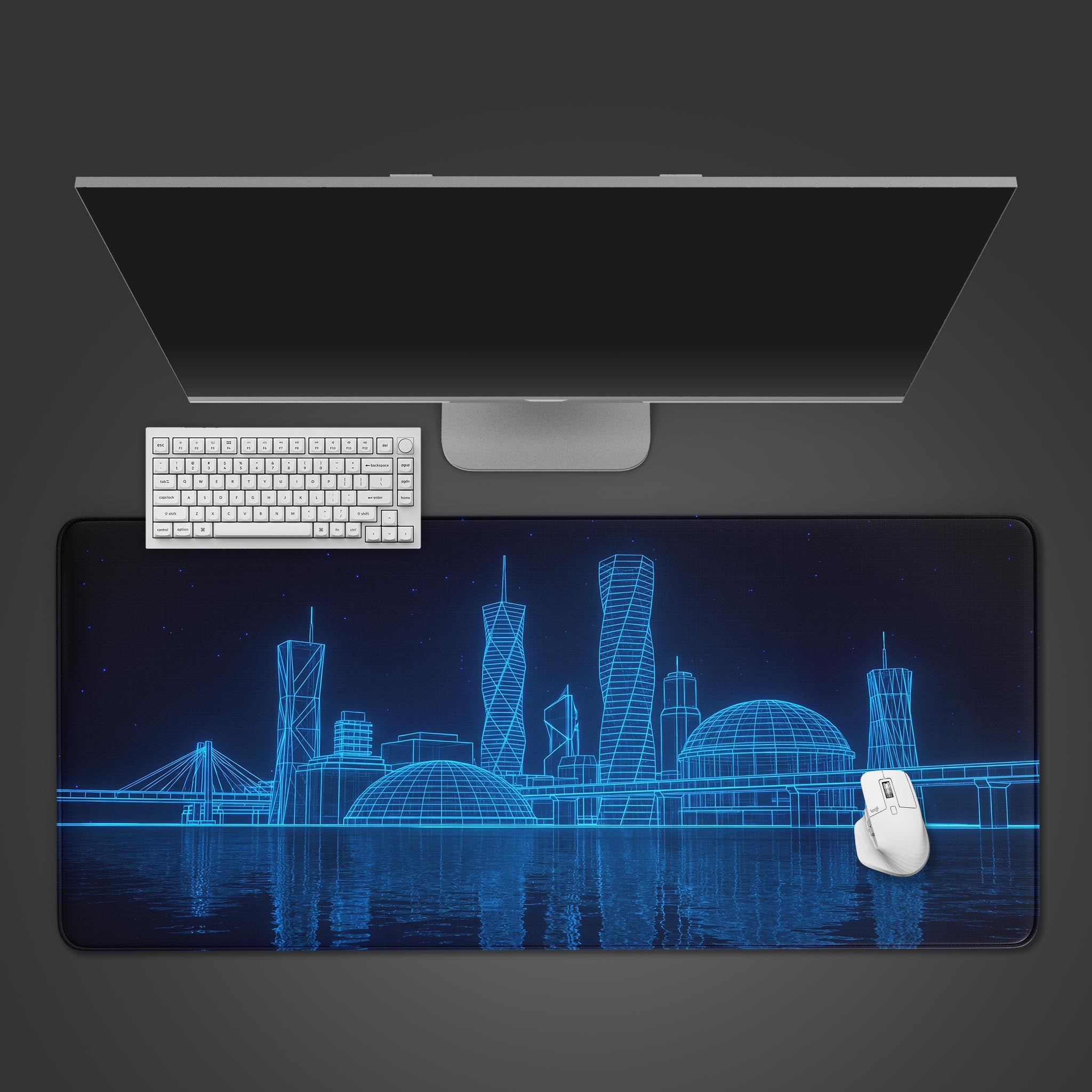 Top-down view of the Digital Skyline gaming desk mat, showing its blue wireframe city design beneath a sleek monitor, white keyboard, and mouse. - Epic Design Pads & Mousepads