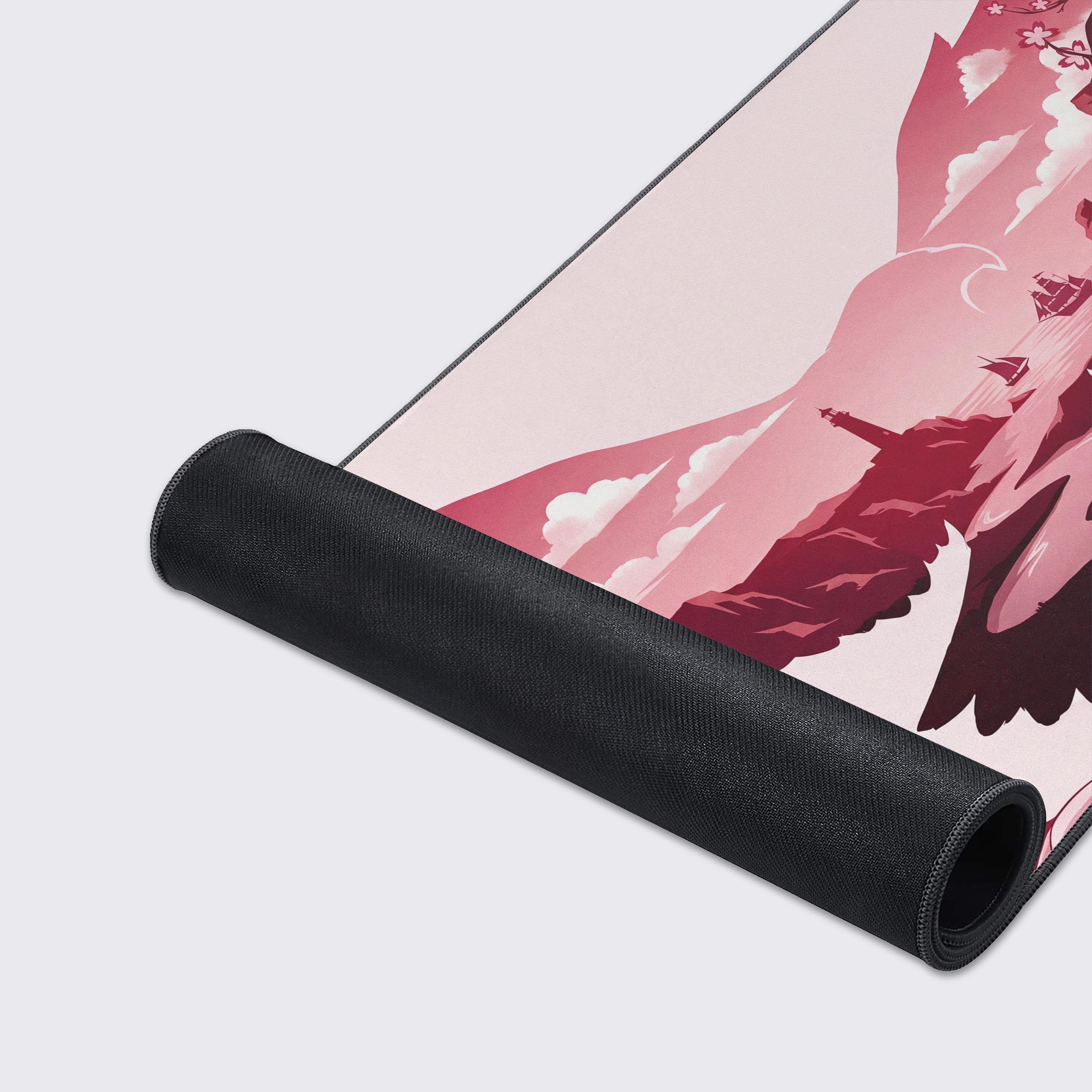The pink and burgundy eagle landscape desk mat showing its smooth surface and water-proof features icons