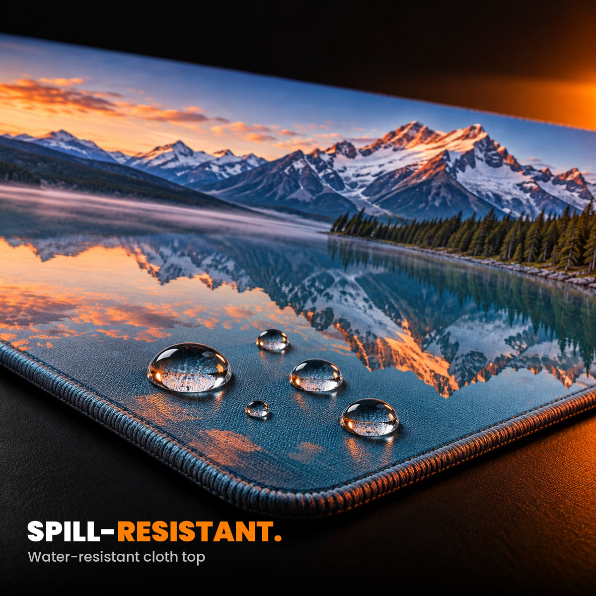 Custom desk mat close-up: water beading on the spill-resistant printed cloth top, stitched edge