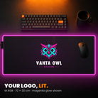 M RGB Custom Desk Pad - example: edge lit magenta, with a studio's owl logo in the middle