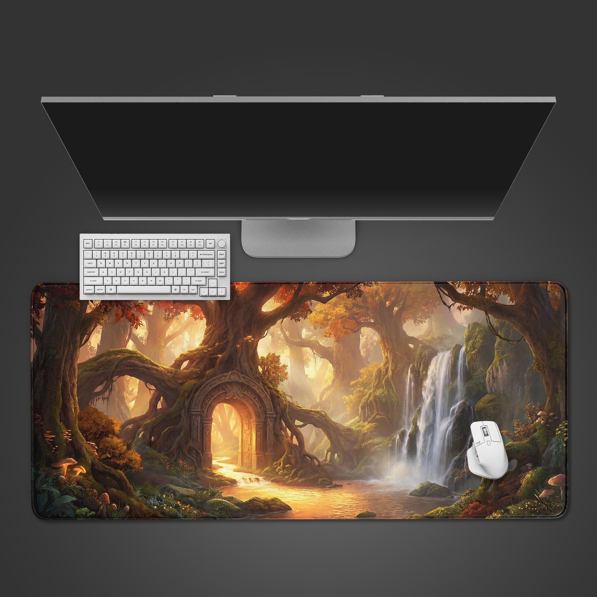 Top-down view of the Eternal Gateway Gaming Desk Mat, showcasing the enchanted forest design beneath a white keyboard and mouse on a dark desk. - Epic Design Pads & Mousepads