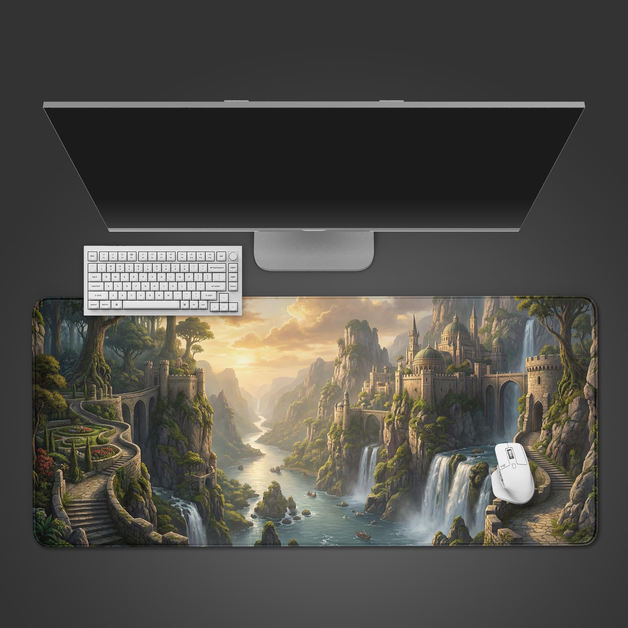 A top-down view of the Ethereal Ascent gaming desk mat, featuring a fantasy castle landscape, with a white keyboard and mouse neatly placed on it under a monitor. - Epic Design Pads & Mousepads