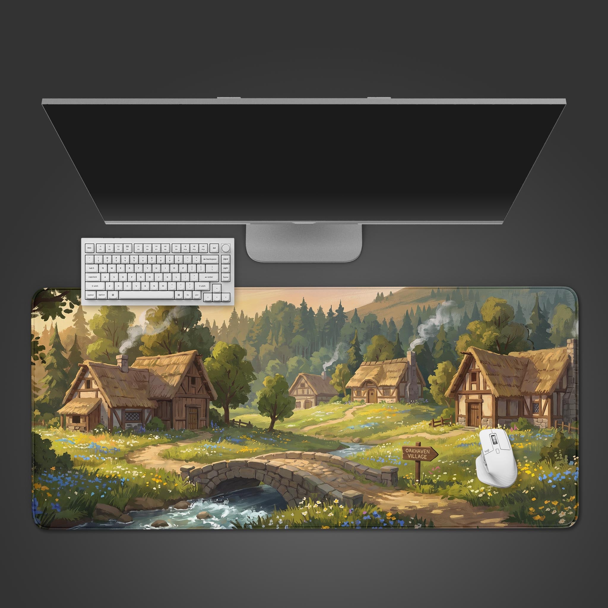 A desk mat featuring a cozy fantasy village with thatched cottages, a stone bridge, and lush green meadows