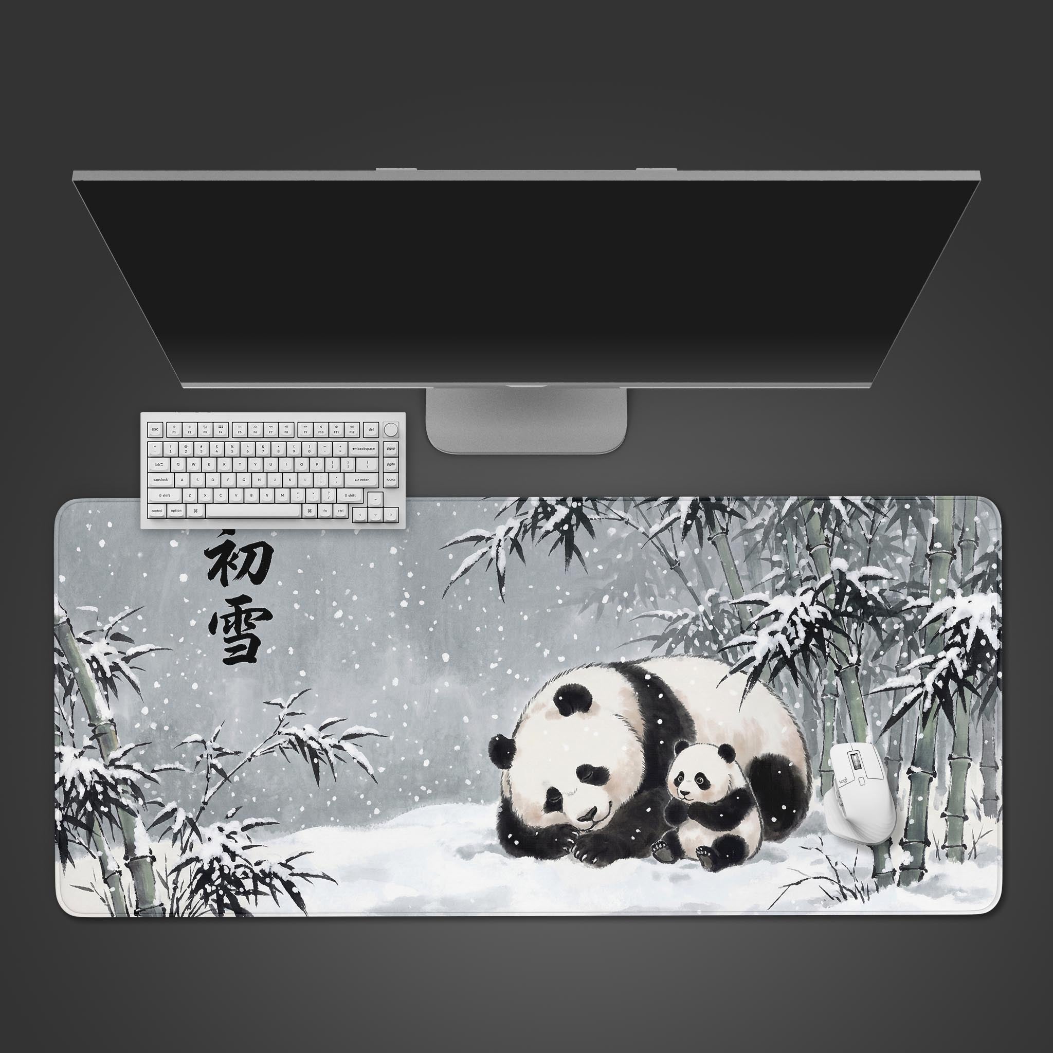 A top-down view of the First Snow panda gaming desk mat. A white keyboard and mouse are placed on the Japanese ink-wash design showing a panda family in a snowy bamboo forest. - Epic Design Pads & Mousepads