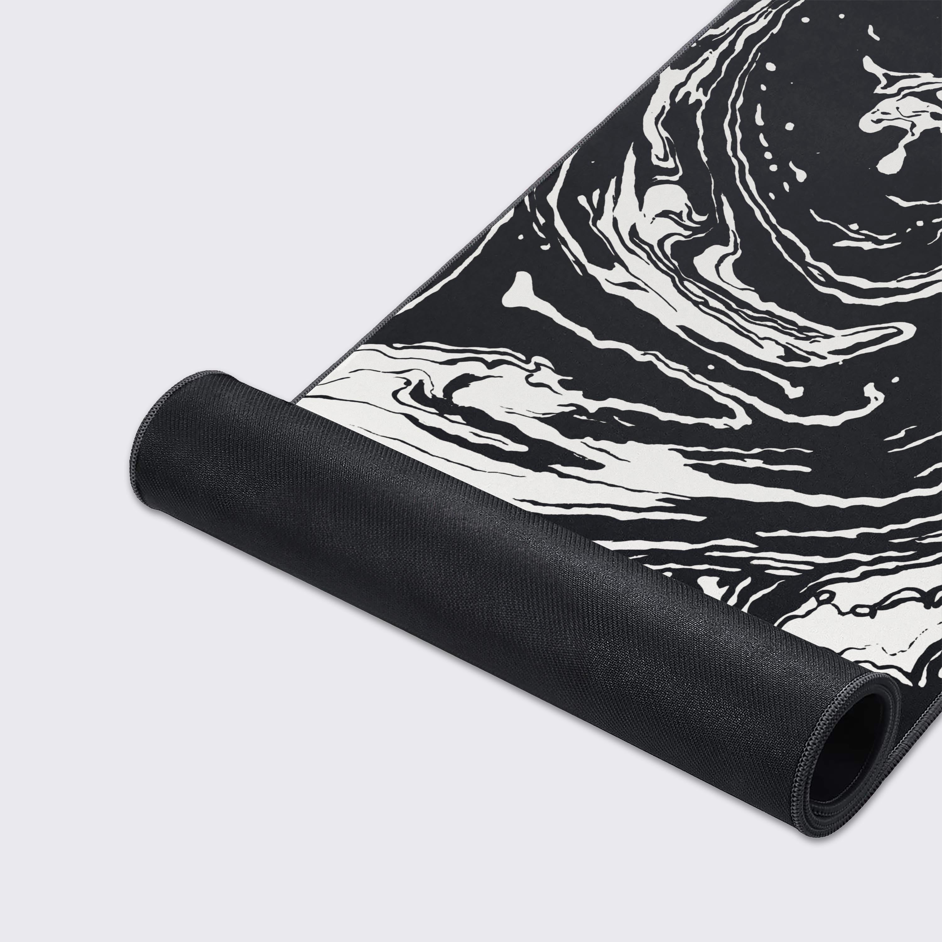 A modern desk setup featuring the black and white fluid art mouse pad, adding a minimalist vibe.