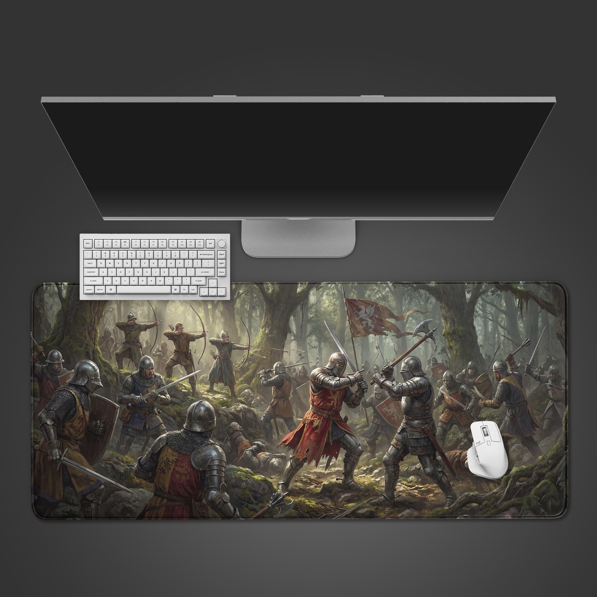 The Forest Ambush Gaming Desk Mat displayed on a desk with a white keyboard and mouse, showcasing the epic medieval battle scene from a top-down view. - Epic Design Pads & Mousepads