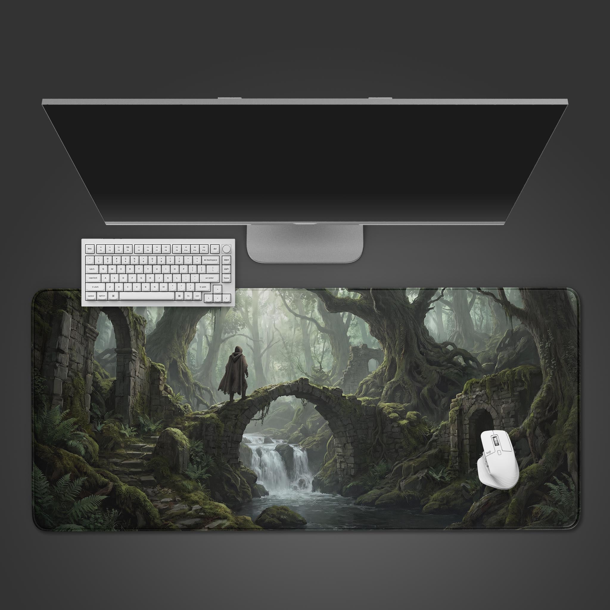 Ancient Forest Ruins fantasy desk mat featuring a cloaked figure on a mossy stone bridge over a waterfall