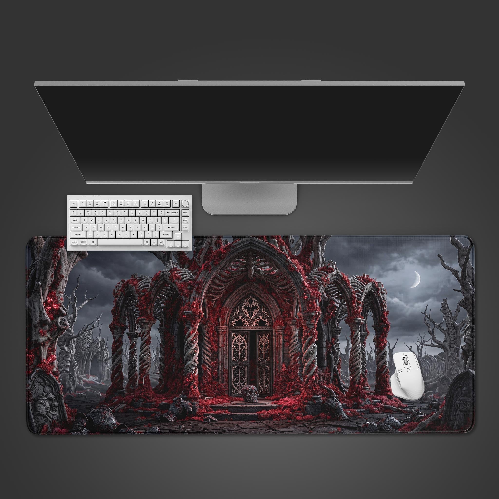 A top-down view of the Forsaken Shrine gaming desk mat, showcasing its dark fantasy bone cathedral design under a monitor, keyboard, and mouse. - Epic Design Pads & Mousepads