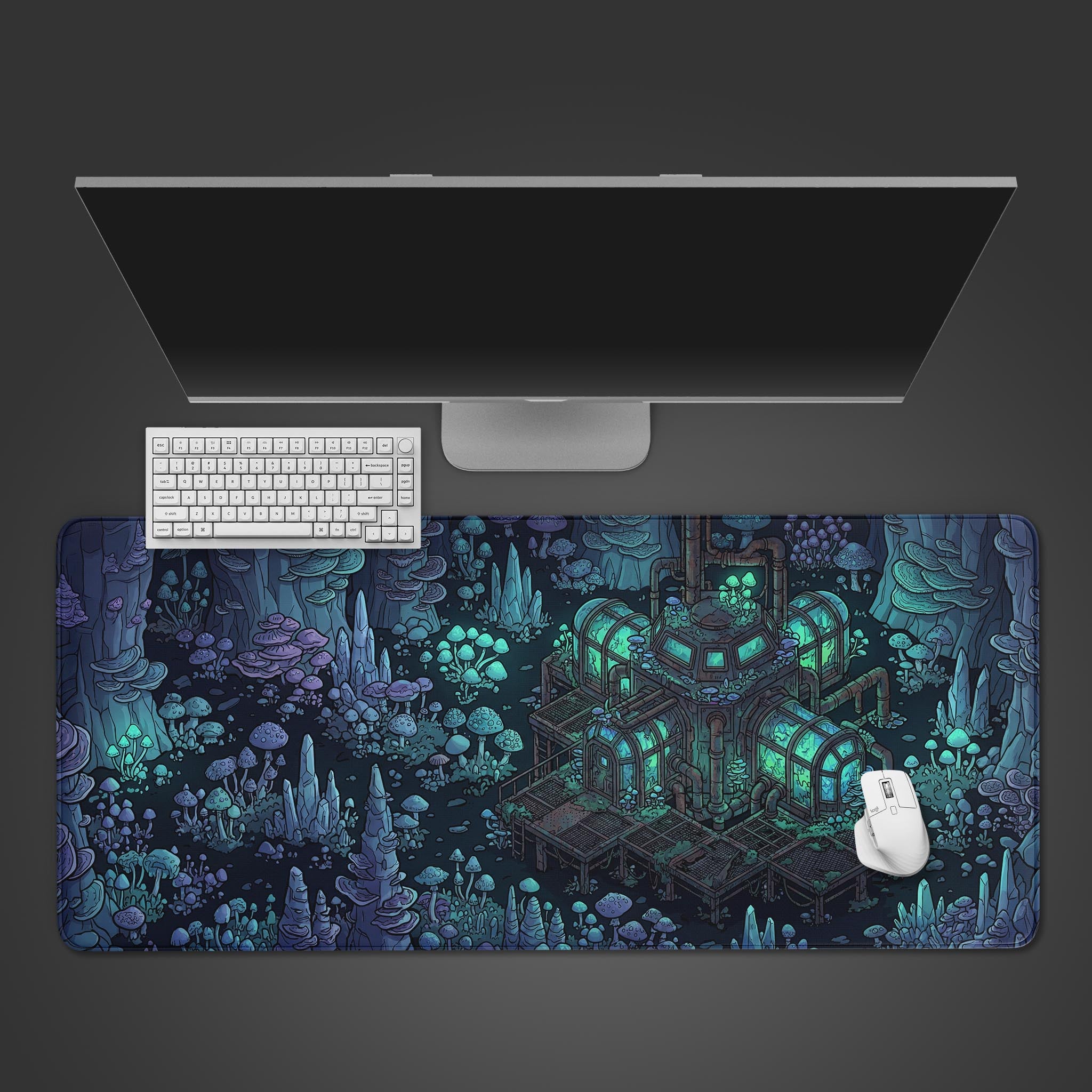 Top-down view of the Fungal Frontier gaming desk mat with its sci-fi mushroom cave art. A white keyboard, mouse, and sleek monitor complete the desk setup. - Epic Design Pads & Mousepads