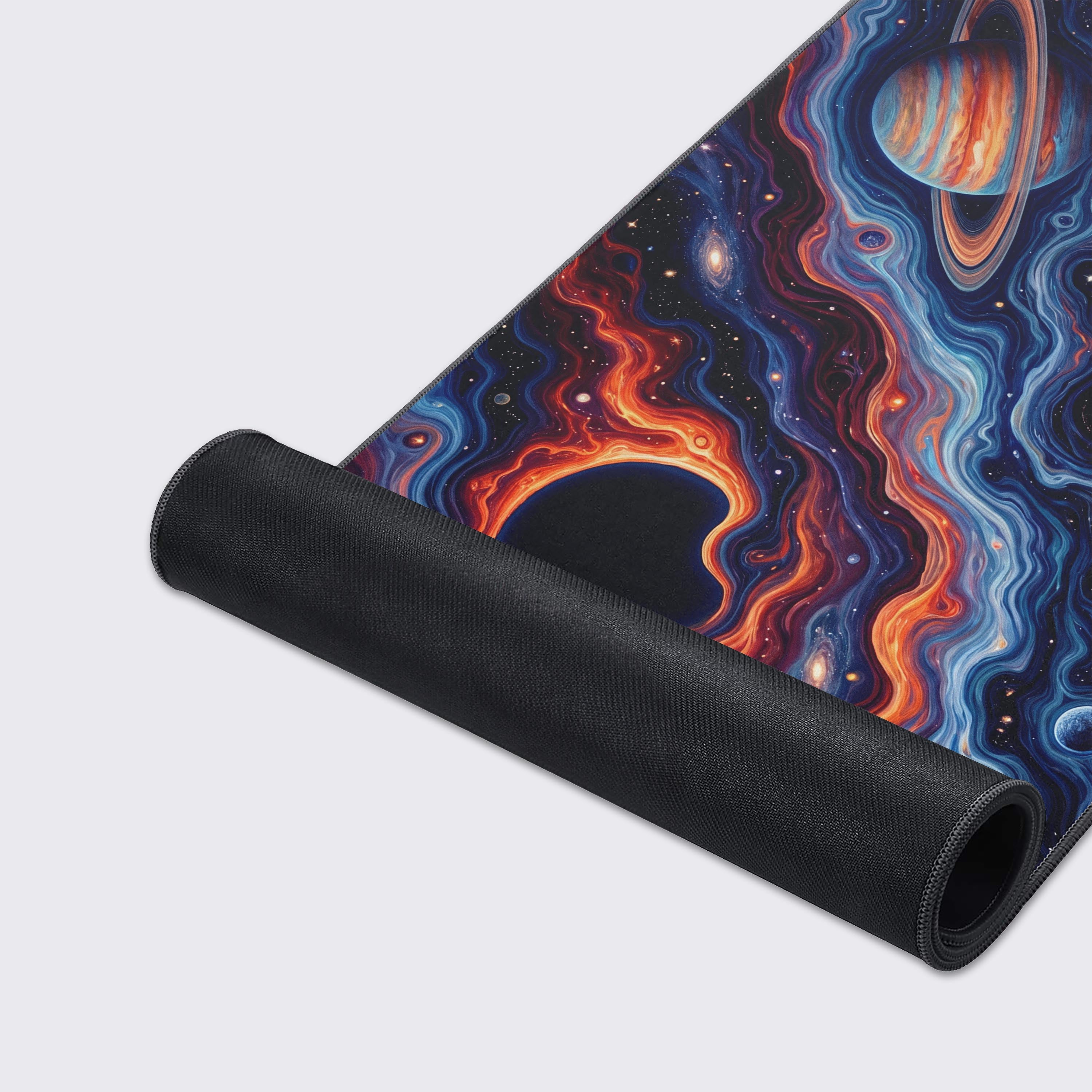 Extended gaming mouse pad with a mesmerizing cosmic vortex design displaying planets and black holes across the universe.