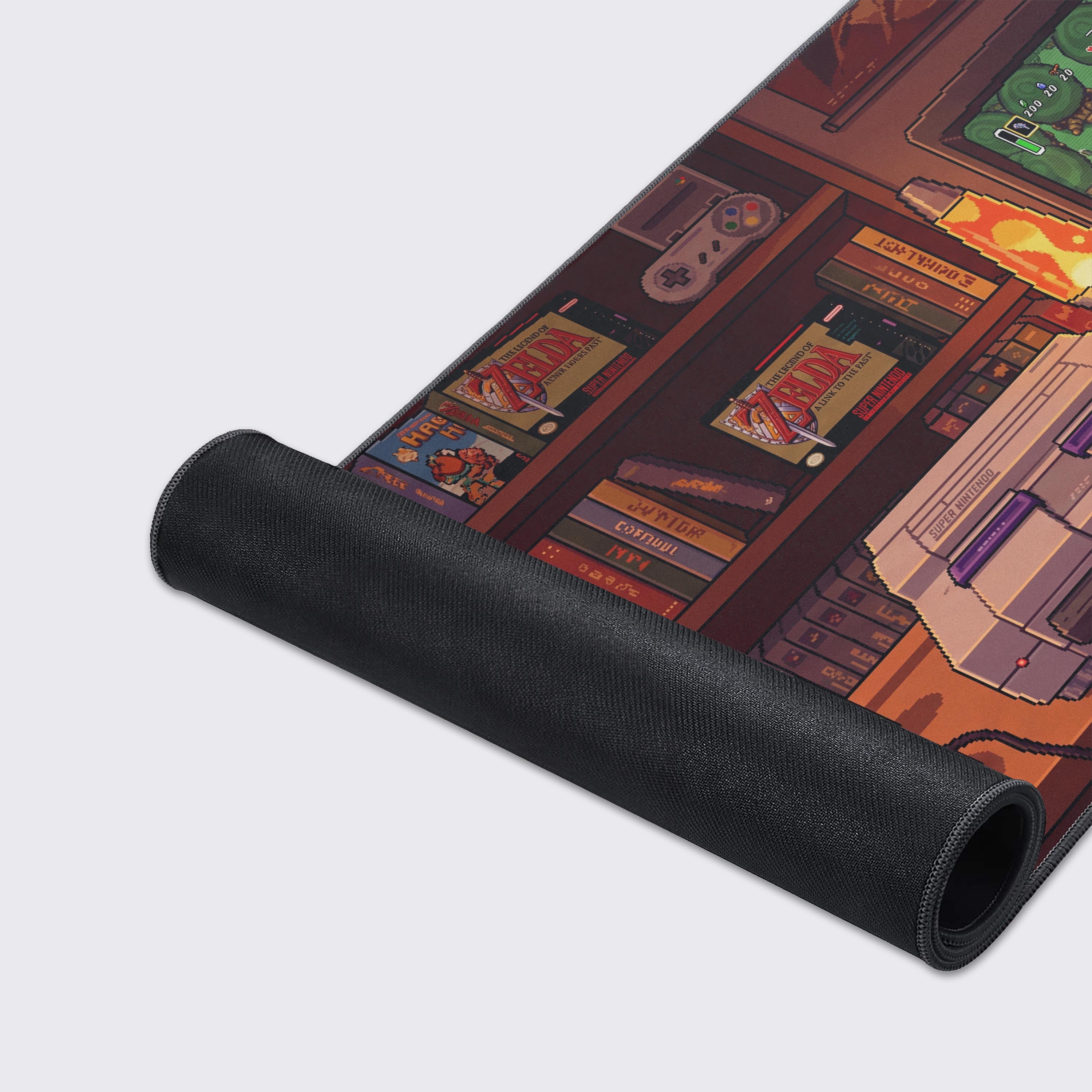 Detail of the desk mat artwork displaying a classic gray 16-bit console with two controllers and a mug of coffee.