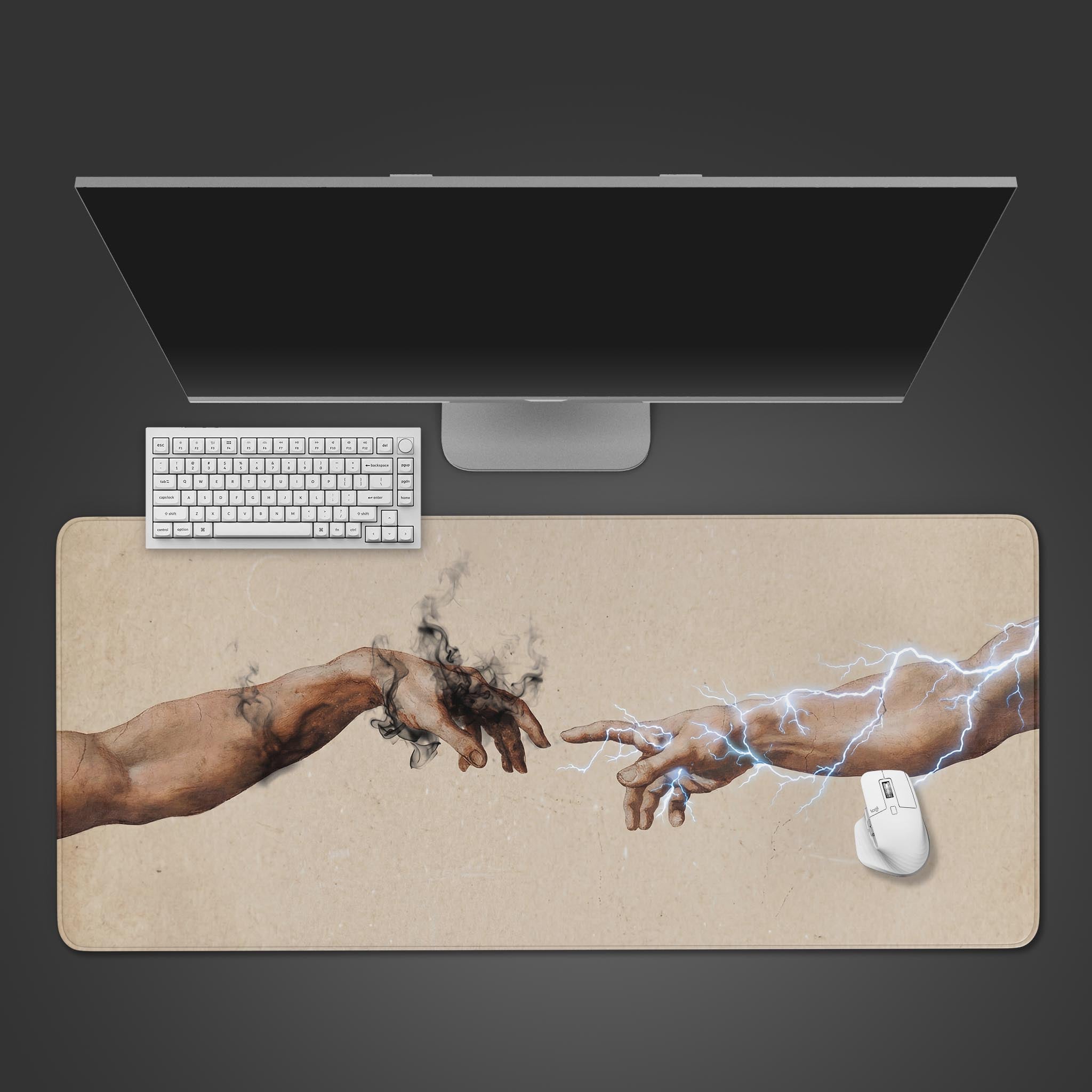 Top-down view of the Genesis Spark gaming desk mat, featuring the iconic hands artwork. A white keyboard and mouse are positioned on the mat below a monitor. - Epic Design Pads & Mousepads