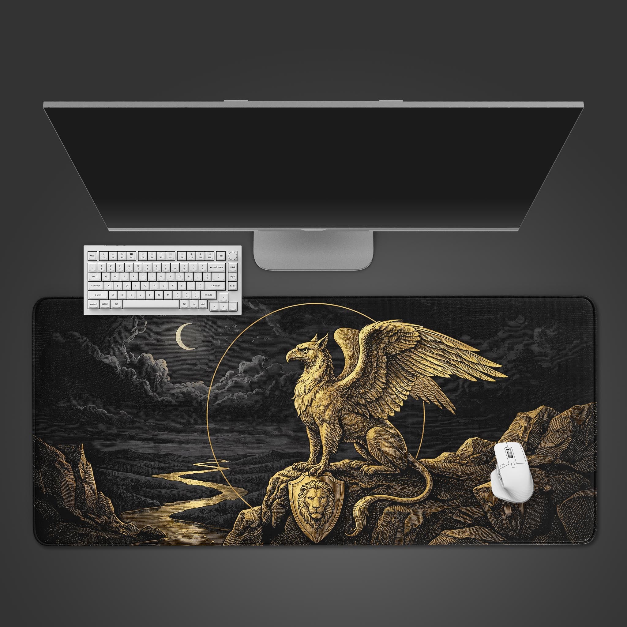 The Gilded Gryphon gaming desk mat displayed on a dark surface with a white keyboard and mouse, showcasing the full gold mythological creature design from a top-down view. - Epic Design Pads & Mousepads