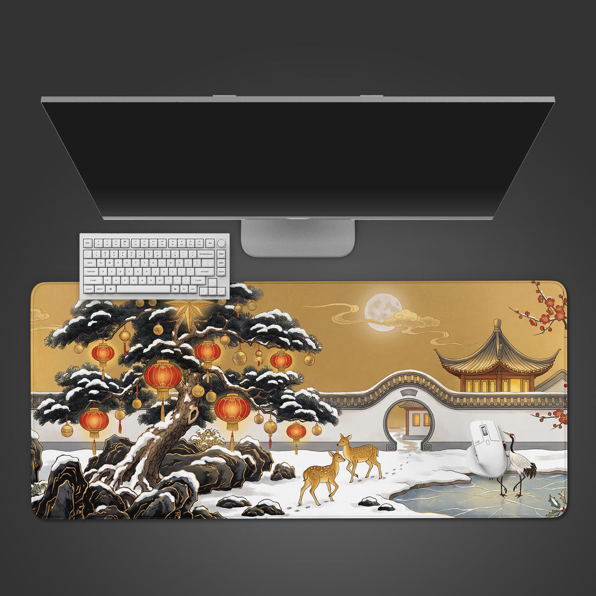 Top view of a gold christmas chinese ink desk mat with snowy lantern pine and deer, white keyboard, mouse and monitor